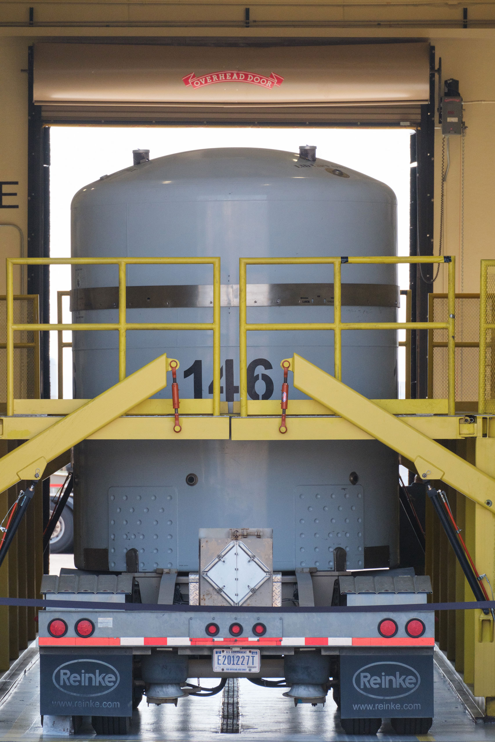 Radioactive waste transportation containers are loaded onto the beds of semi-trucks at the Radioassay and Nondestructive Testing Facility. (Ramsay de Give for TIME)