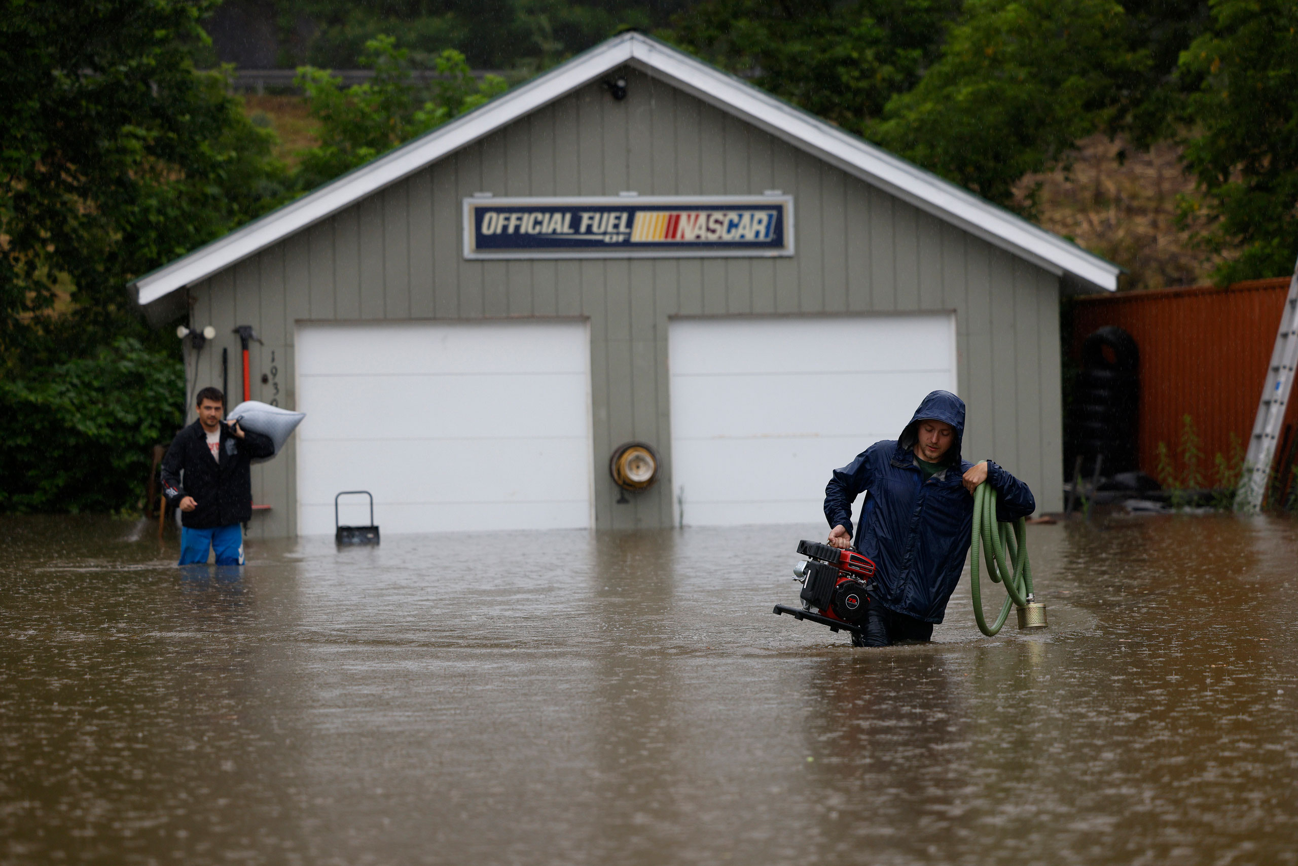 Residents remove their possessions from their home as floodwaters rise in Waterbury, Vt., on July 10. (Jessica Rinaldi—The Boston Globe/Getty Images)
