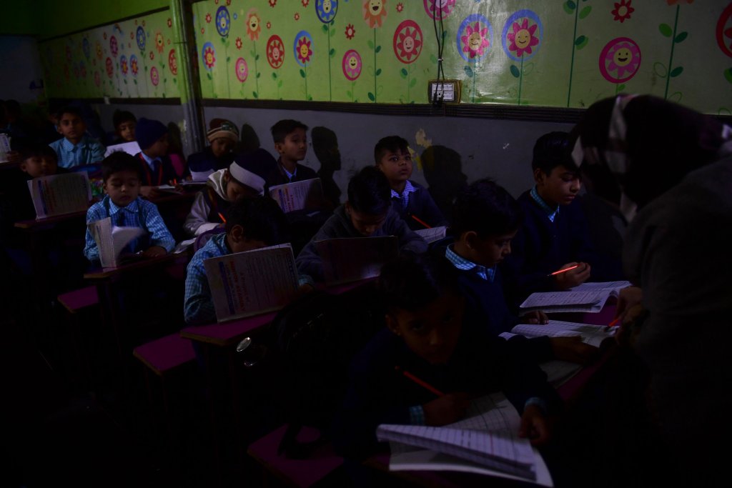 Students attend a class at a private school during a nationwide power outage in Karachi on Jan. 23.
