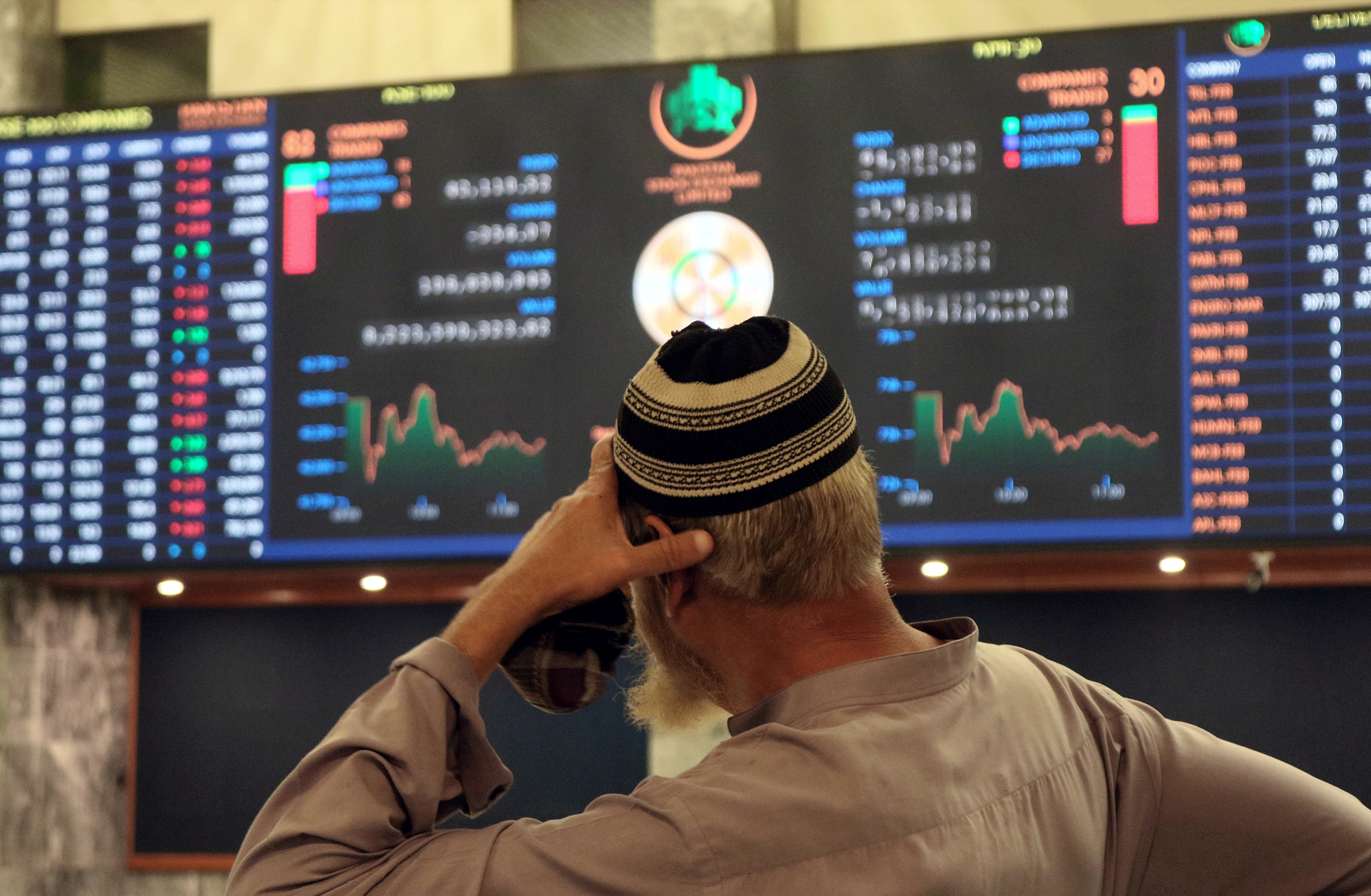 A Pakistani stockbroker monitors the latest share prices during a trading session at the Pakistan Stock Exchange in Karachi, Pakistan, on Feb. 10. The sluggish performance of the market was attributed to the delay in concluding the ninth review of a seven billion US dollar IMF loan program.