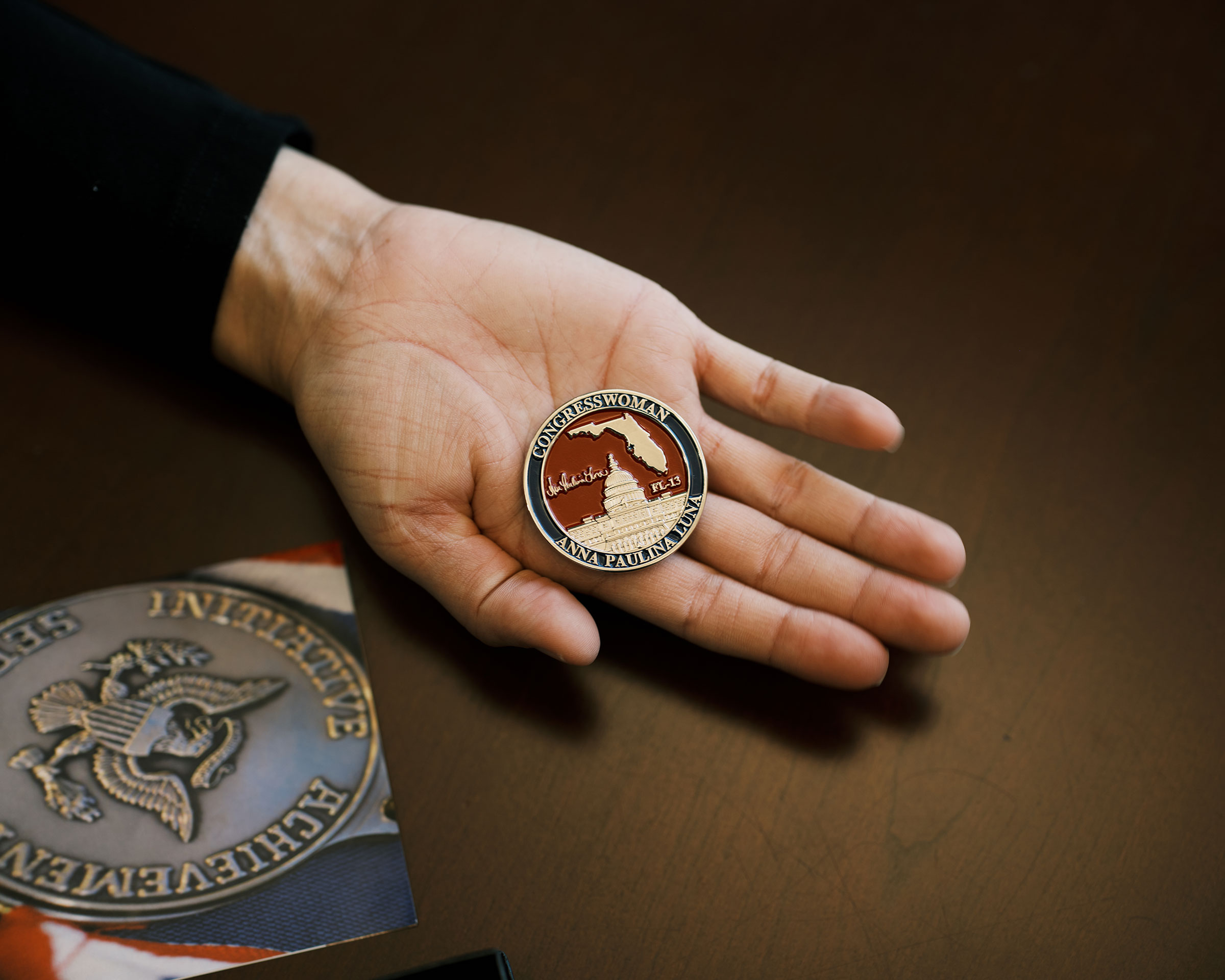 Luna holds a coin emblazoned with her name. (Zack Wittman for TIME)
