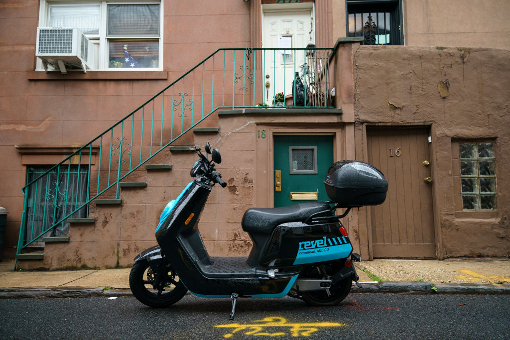 A Revel brand moped sits parked on a residential street, June 18, 2019 in the Brooklyn borough of New York City.  (Drew Angerer—Getty Images)