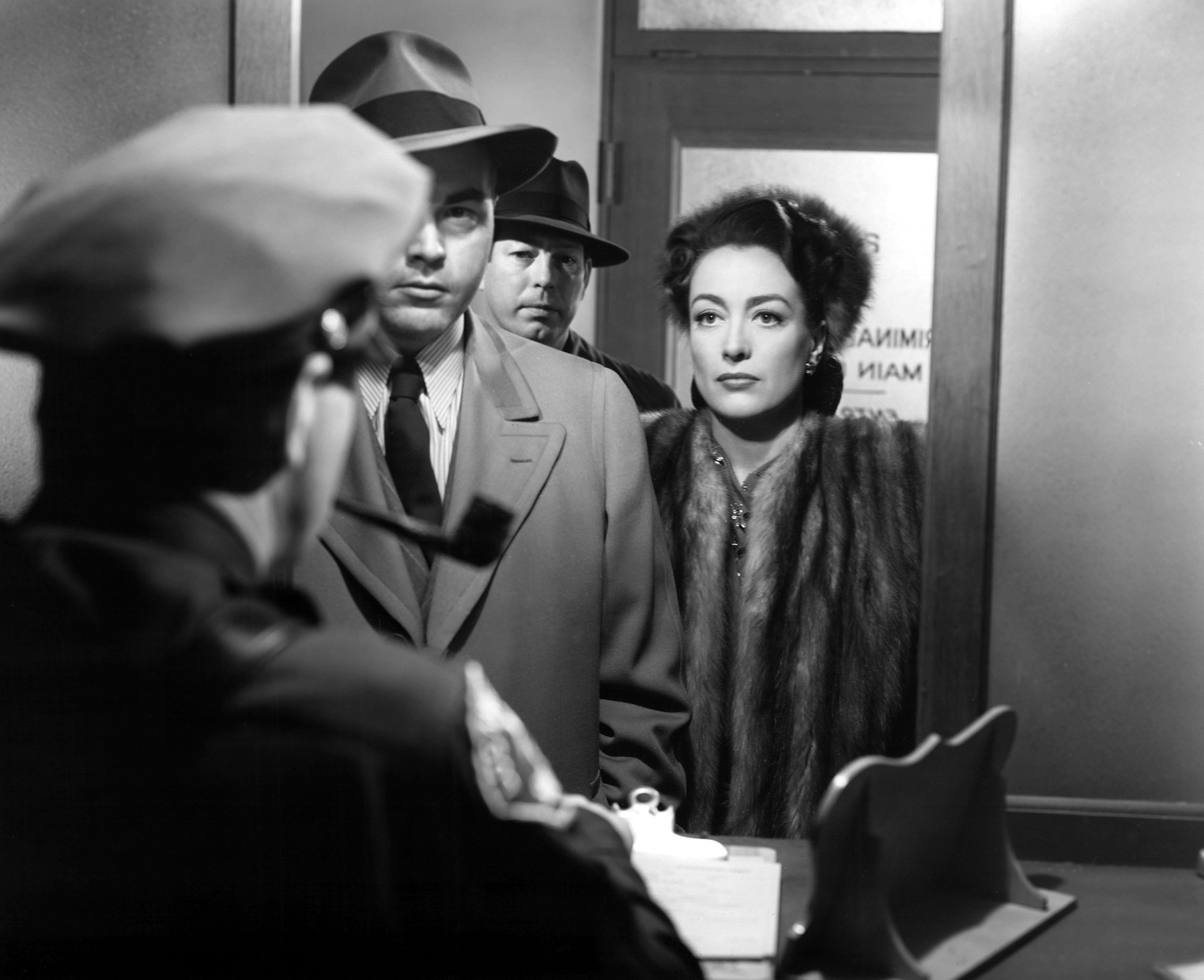 James Flavin, Don O'Connor, and Joan Crawford in <i>Mildred Pierce</i>. (Everett Collection)