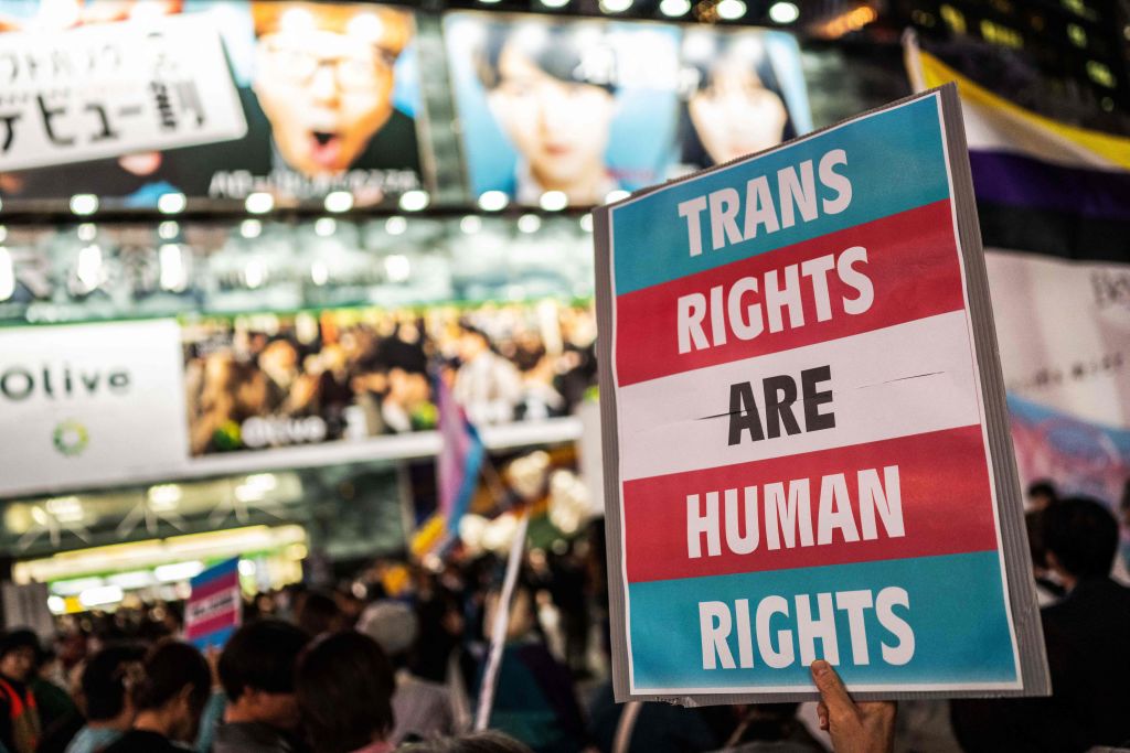 A participant holds up a placard during the International Transgender Day of Visibility rally in Shibuya district of Tokyo on March 31, 2023.