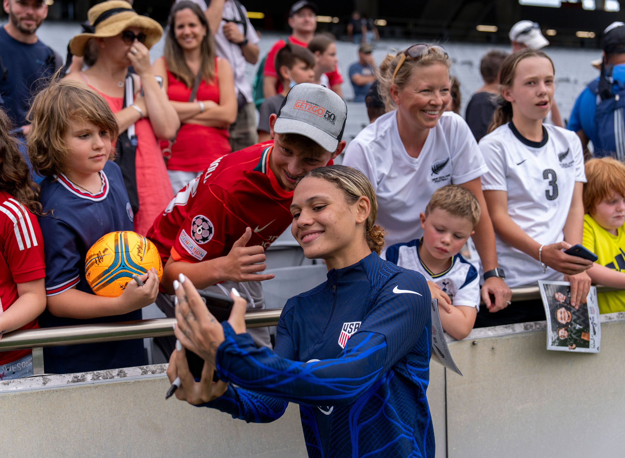 Trinity Rodman takes a selfie with fans after a game between New Zealand and USWNT at Eden Park in Auckland, New Zealand, on Jan. 21, 2023. (Brad Smith—ISI Photos/Getty Images)