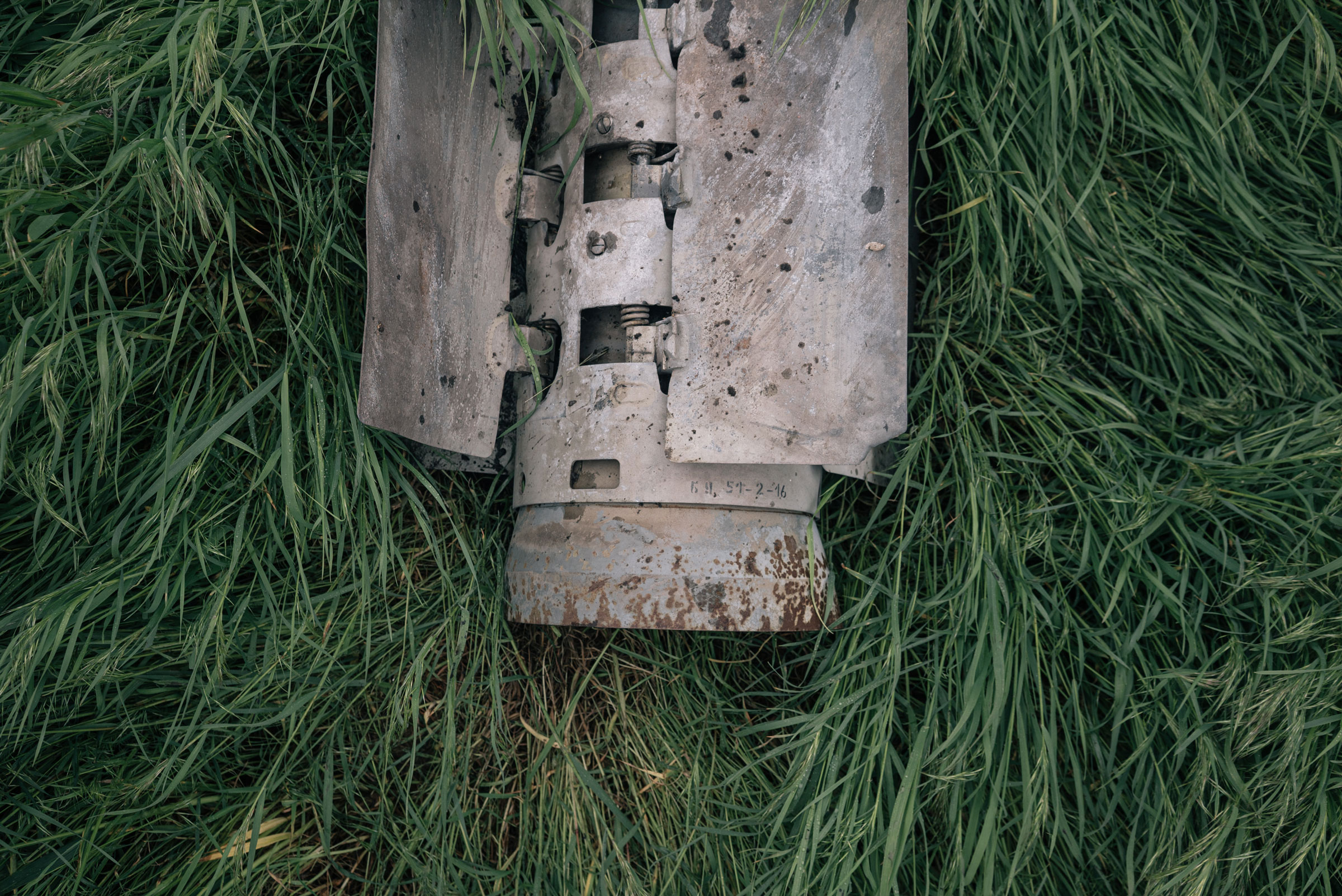 The remains of a rocket that carried cluster munitions found in a field in the countryside of Kherson region, Ukraine, on April 28. (Alice Martins—The Washington Post/Getty Images)