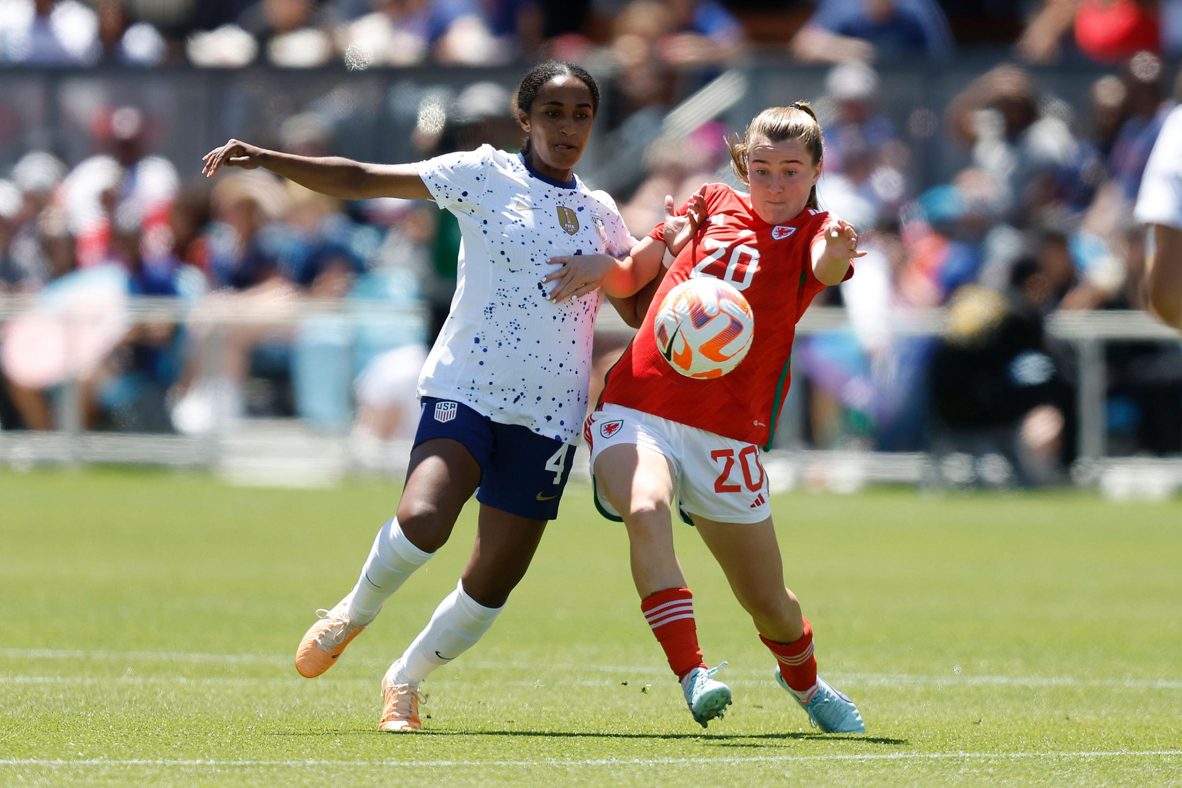 Naomi Girma battles for the ball with Carrie Jones of Wales