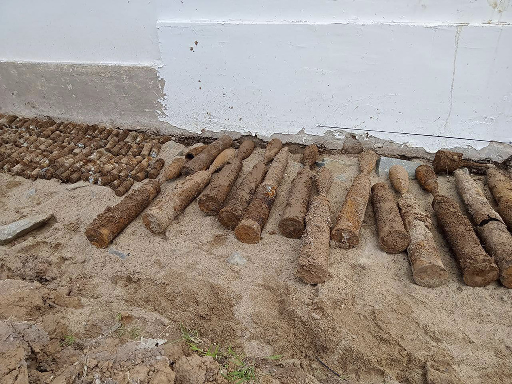A pile of unexploded ordnance at Queen Kosamak High School in Kratie Province, northeastern Cambodia, Sunday, Aug. 13, 2023. (Cambodia Mine Action Center via AP)