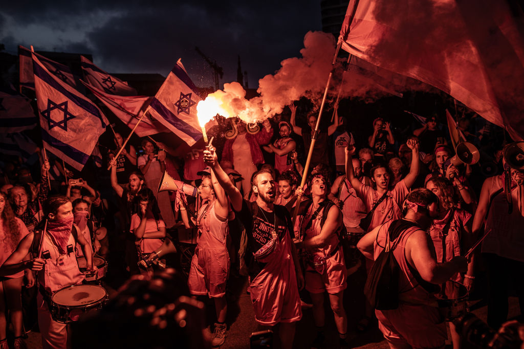 People, carrying flags, various banners and placards, gather to protest Prime Minister Benjamin Netanyahu's judicial reform in Tel Aviv, Israel on August 12, 2023. Protests started 32 weeks ago nationwide.  (Mostafa Alkharouf-Anadolu Agency)