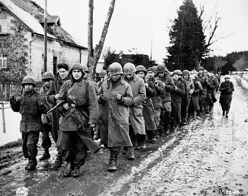American prisoners captured during the Battle of the Bulge march under guard by German soldiers. Dec. 17, 1944  (Corbis via Getty Images)