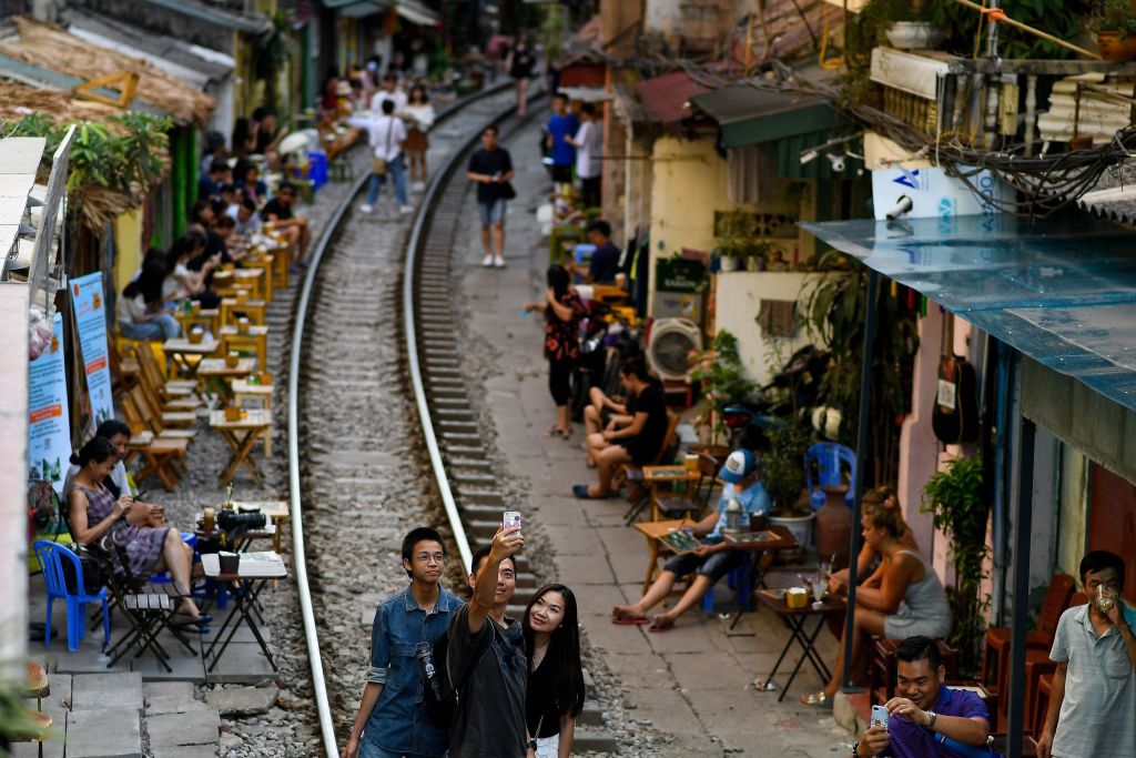 A family takes a selfie on Hanoi's popular Train Street on June 9, 2019. (Manan Vatsyayana—AFP/Getty Images)