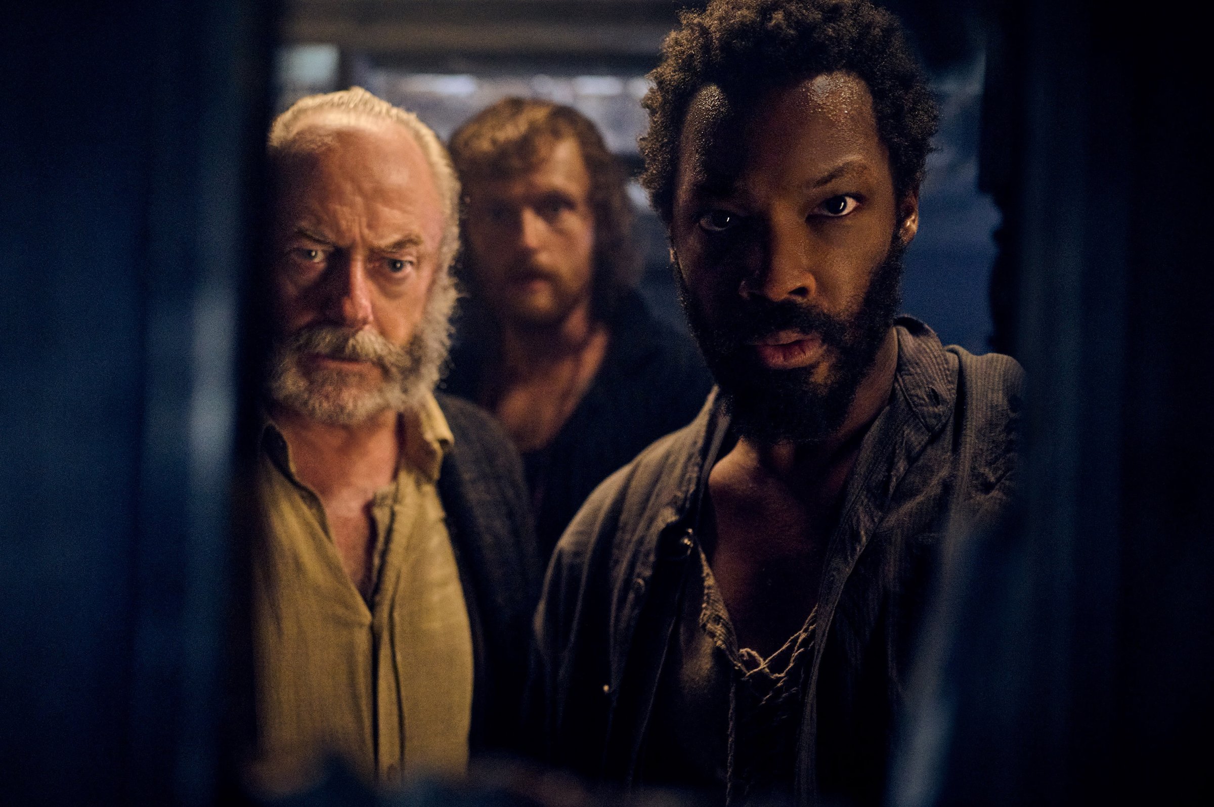 Liam Cunningham as Captain Eliot, Chris Walley as Abrams, and Corey Hawkins as Clemens in 'The Last Voyage of the Demeter'