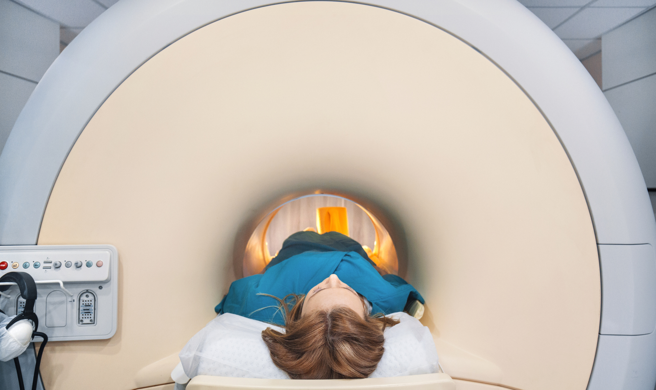 A woman enters an MRI scanner