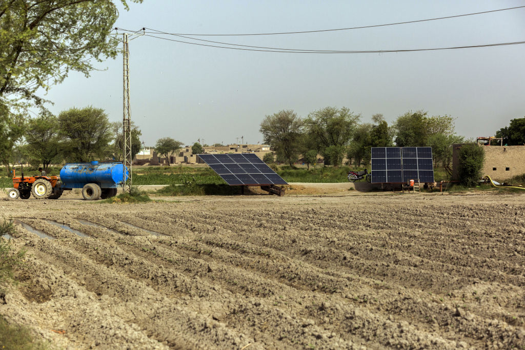 Solar panels installed next to a pumping station at a village in the Dadu district of Sindh, Pakistan on Thursday, June 1, 2023. With Pakistan's monsoon season fast approaching, the country is still reeling from last year when severe flooding in killed over 1,700, displaced 8 million and cost the economy more than $30 billion.  (Asim Hafeez—Bloomberg/Getty Images)