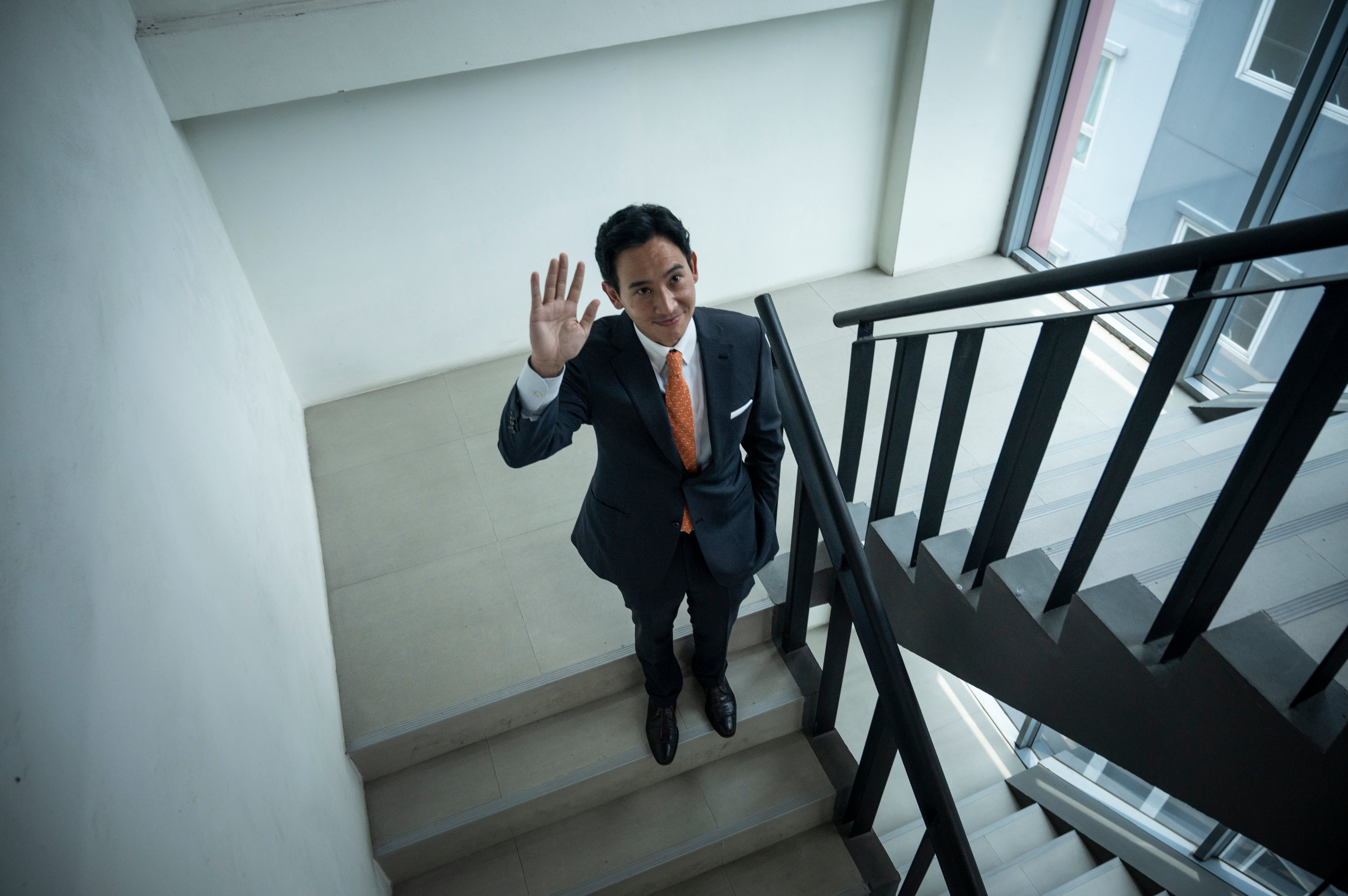 Pita walks down a staircase at the Move Forward Party headquarters in Bangkok on May 15, 2023. (Sirachai Arunrugstichai—Getty Images)