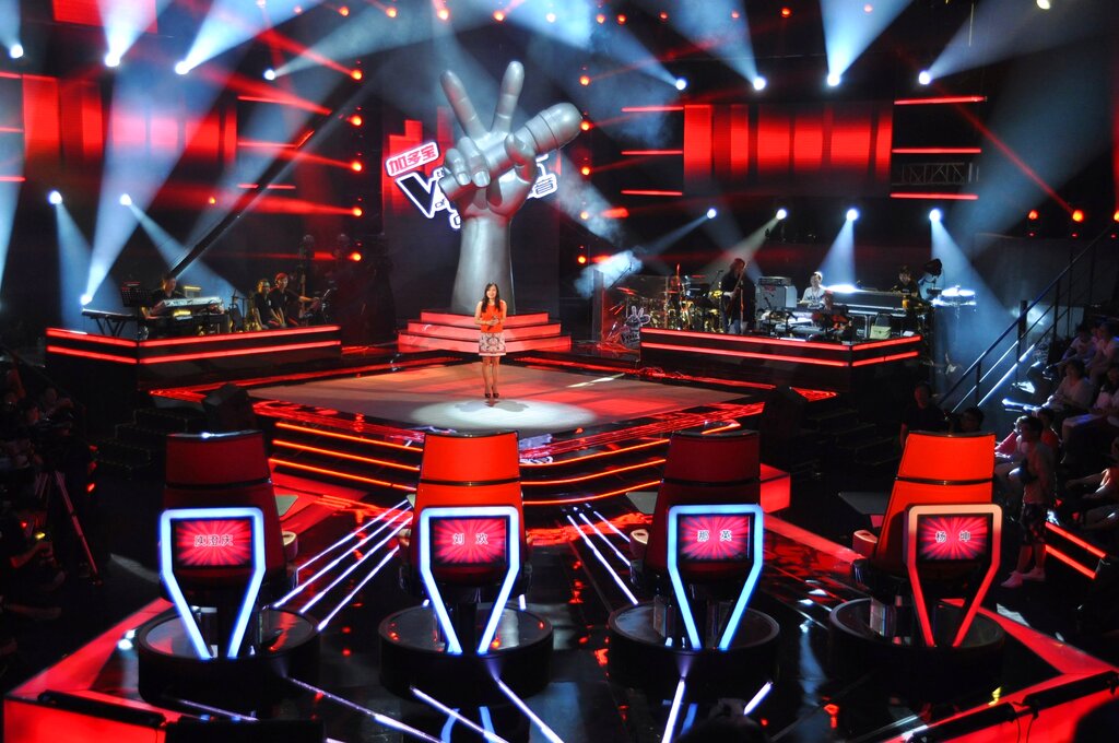 A contestant stands on stage during an episode of the popular reality singing TV show 'The Voice of China' in Shanghai, July 4, 2012. (Zhong Fubao—Imaginechina/AP)