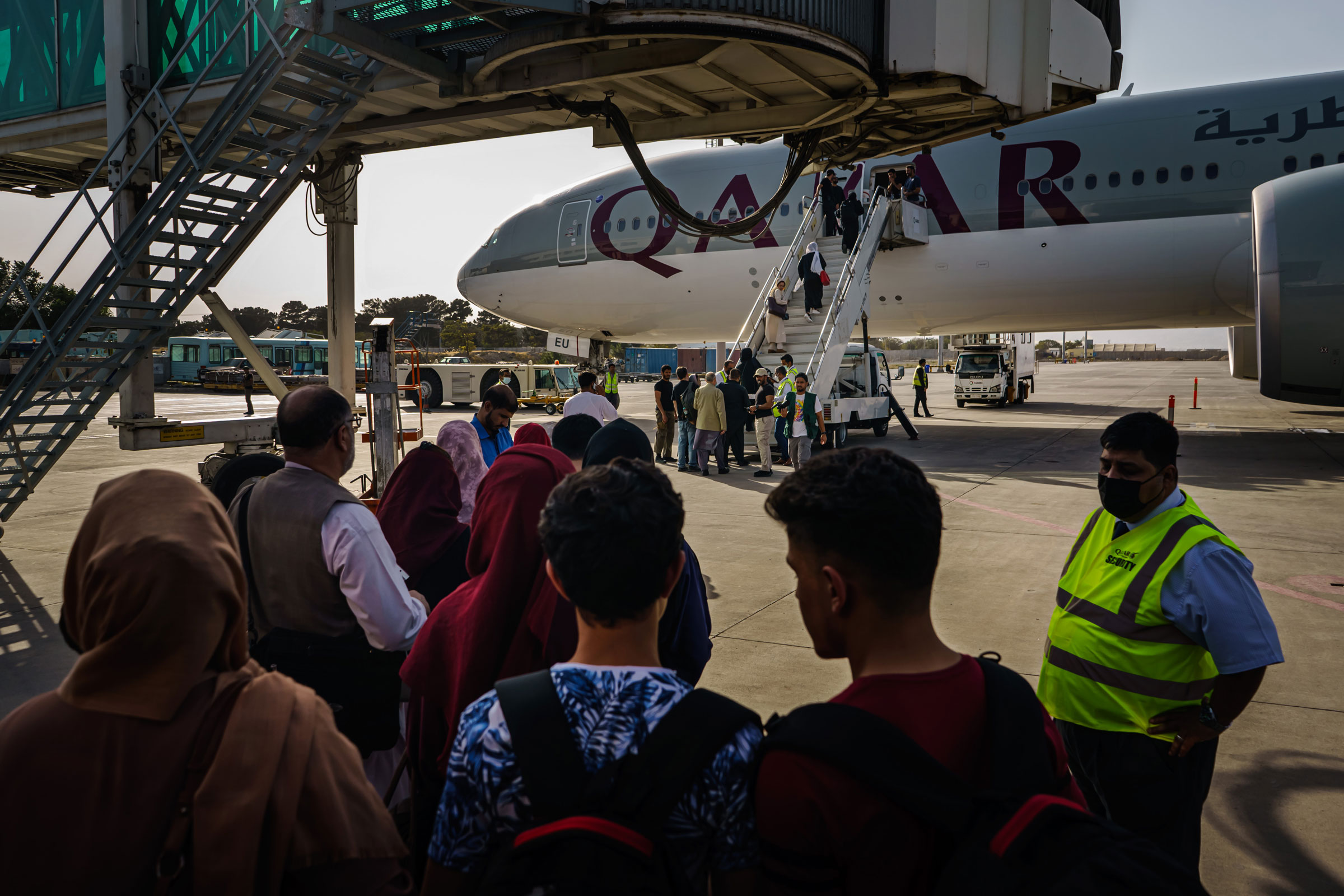 People prepare to board an evacuation flight out of Kabul, Afghanistan, on Oct. 3, 2021. (Marcus Yam—Los Angeles Times/Getty Images)