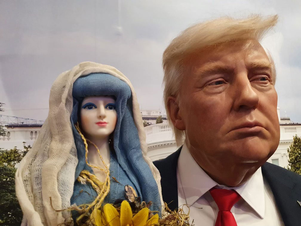 The Our Lady of the Manifest doll with a wax statue of Donald Trump