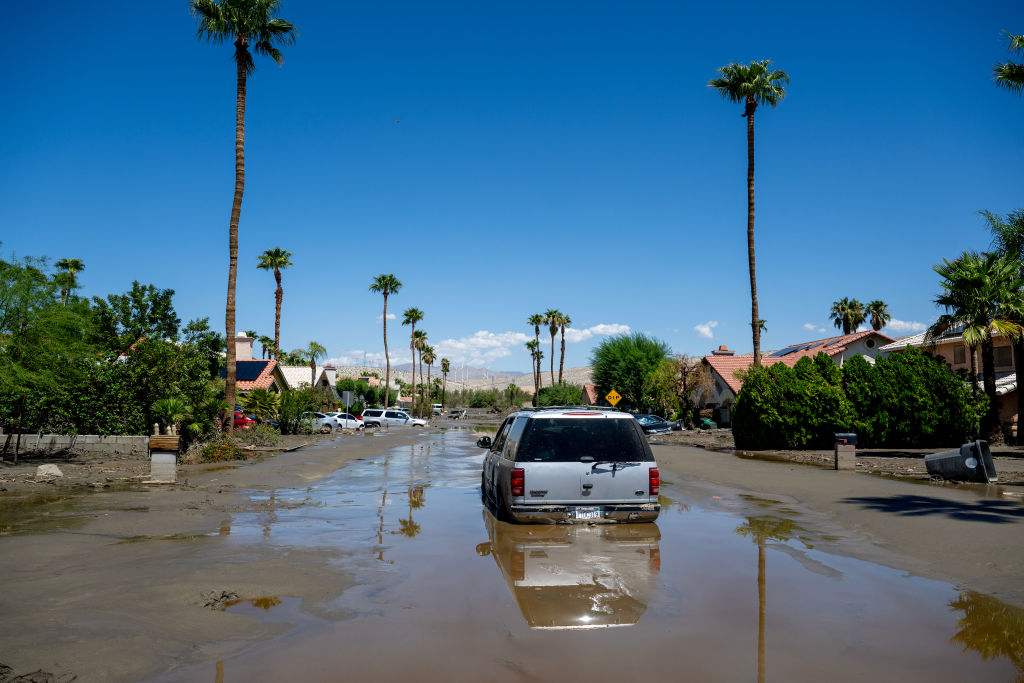 An SUV is  one of many stuck vehicles still stuck in the mud and flood waters after tropical storm Hilary sent damaging flood water to Horizon Road on Aug. 22, 2023 in Cathedral City, California. (Gina Ferazzi / Los Angeles Times—Getty Images)