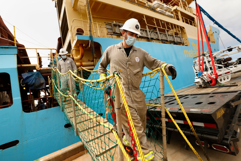 Workers disembark a research vessel in San Diego, Calif. in June 2021, that returned from the Clarion Clipperton Zone of the Pacific Ocean, where soil, water, and wildlife samples were obtained from deep in the ocean as part of the research to see the effects mining will have on the environment. Gerard Barron, Chairman and CEO of The Metals Company, plans for his company to mine the seafloor for nickel, cobalt, and manganese.