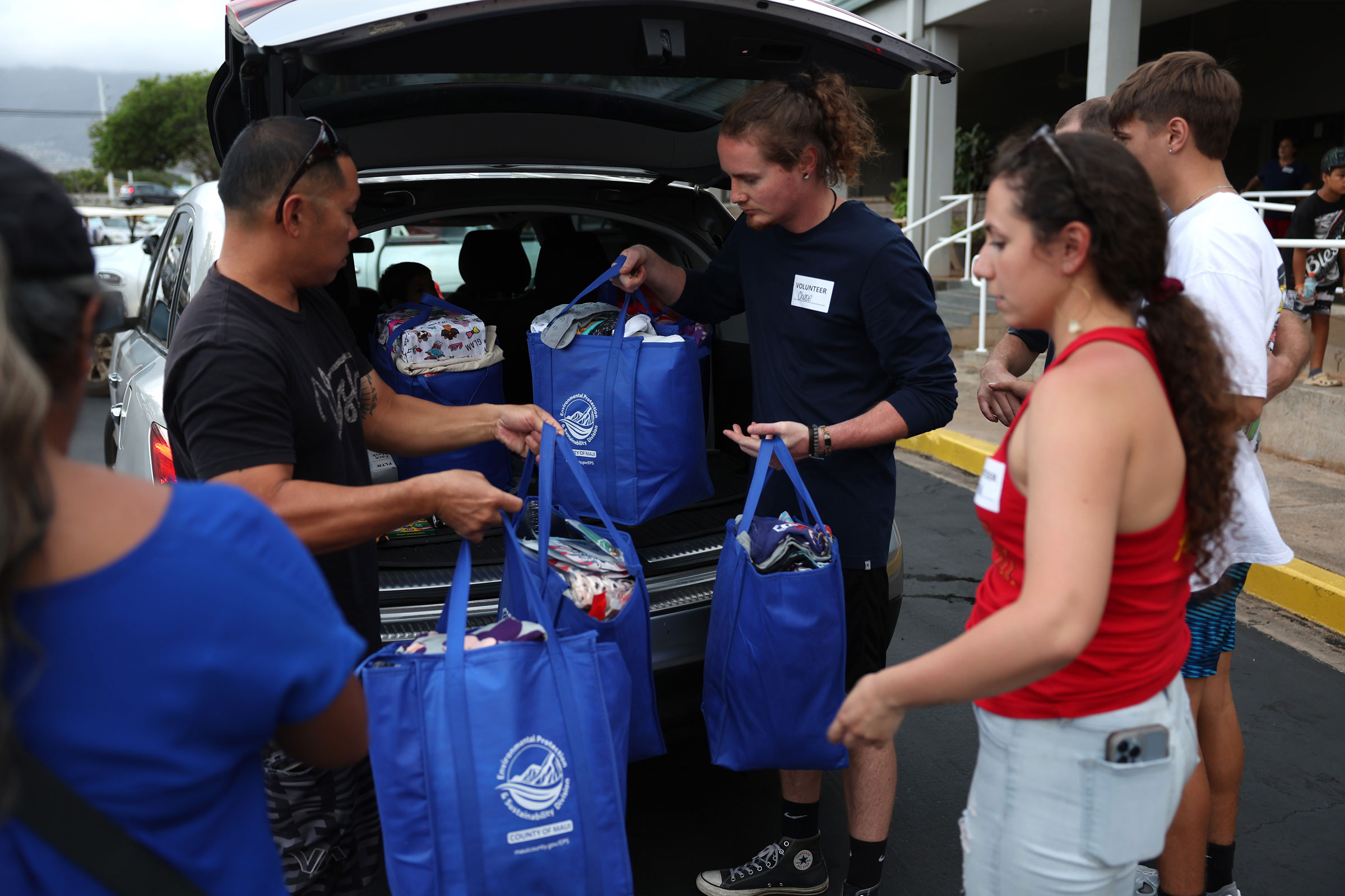 Volunteers with King’s Cathedral Maui help unload a donation of supplies