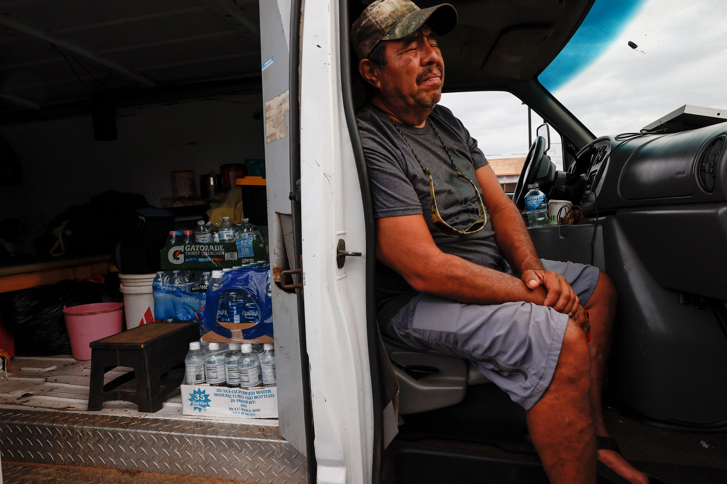 Jesus Vasquez sits in his van waiting to return to his home near Lahaina, on Aug. 10, 2023. He and other evacuees camped in a parking lot along the Honoapiilani Highway, hoping to be allowed back into Lahaina, two days after a devastating wildfire tore through the community. (Robert Gauthier—Los Angeles Times/Getty Images)