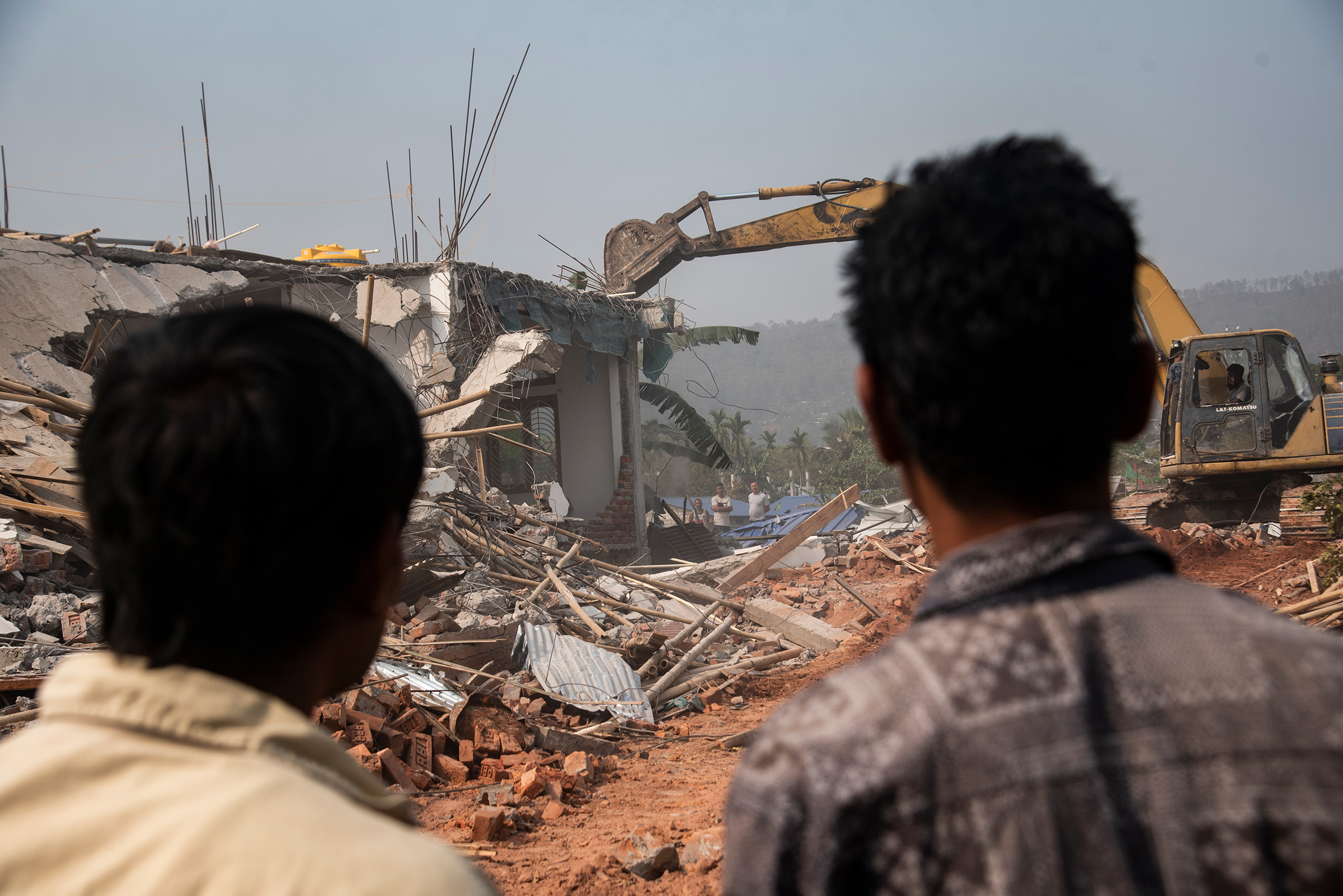 A bulldozer being used to demolish alleged illegal structures during an anti-encroachment eviction drive by Guwahati Metropolitan Development Authority, on Feb. 27 in Guwahati, India.