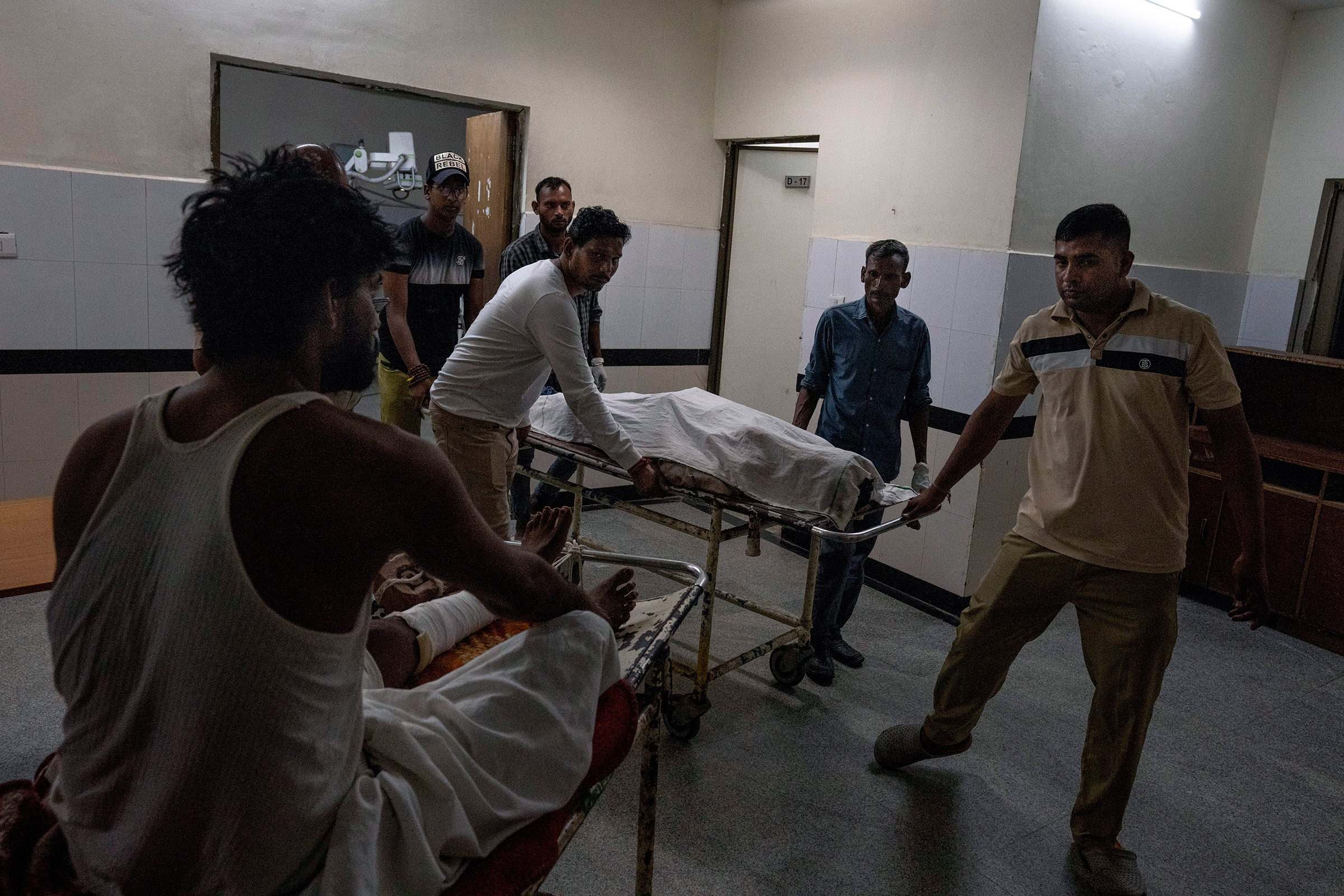 Relatives of Abhishek, who was killed in communal clashes, carry his body on a stretcher at a hospital in Nuh, Haryana state, on Aug. 1.