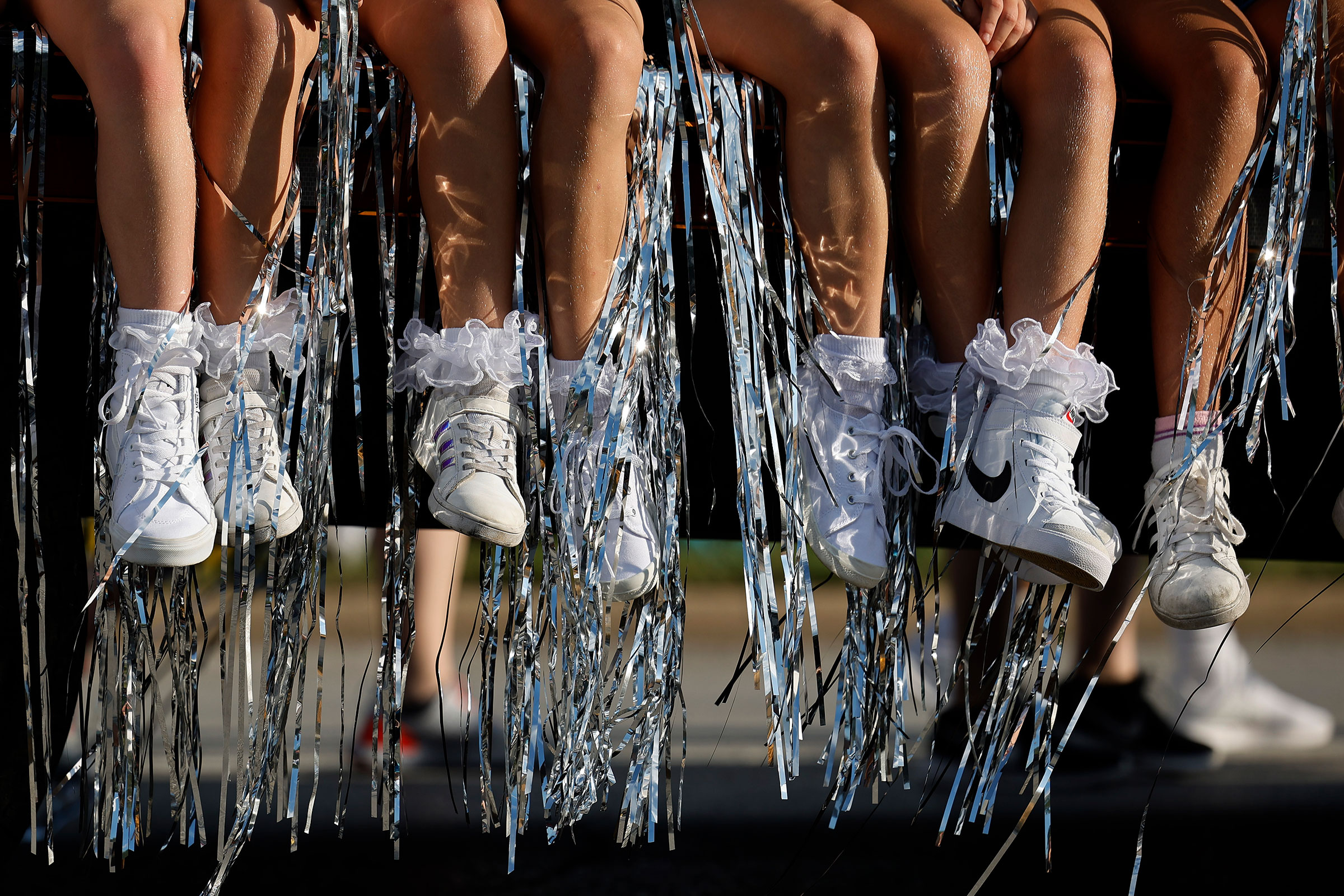 Tinsel and tennis shoes hang off the side of a float in the Iowa State Fair Kick-Off Parade
