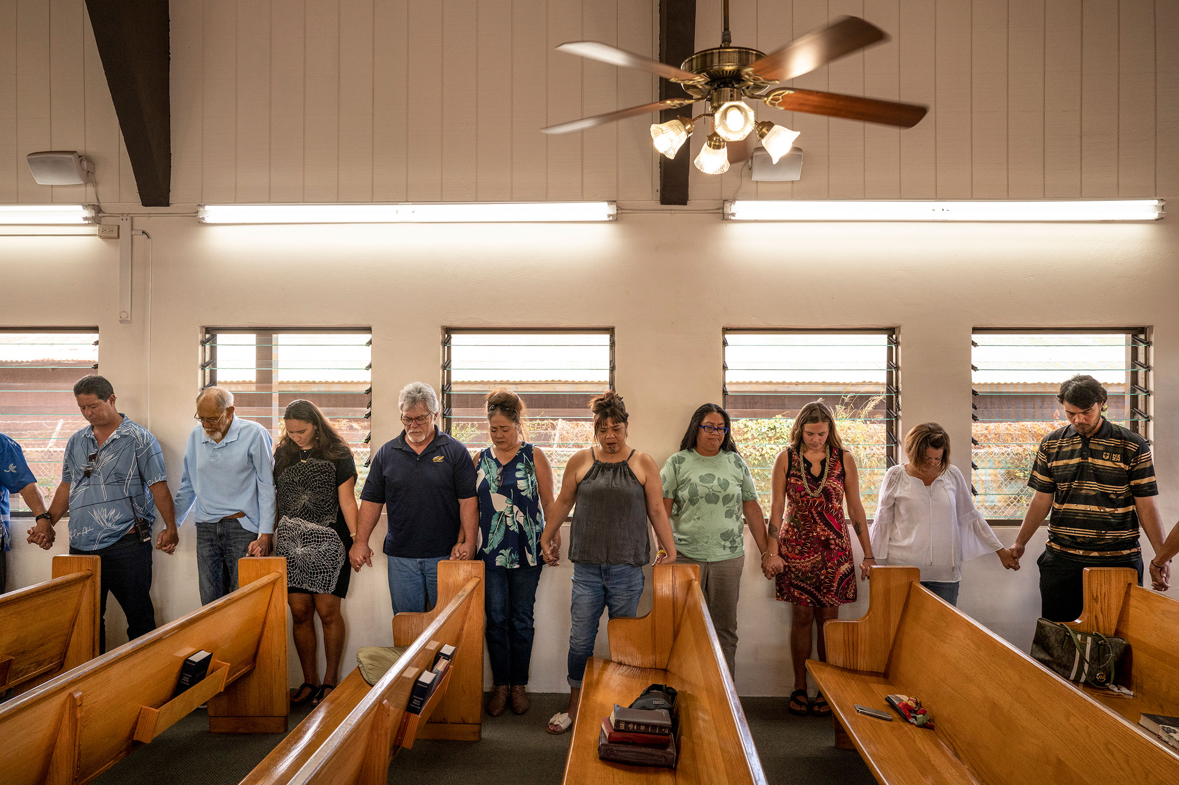 At the first Sunday service since the deadly fires last week, parishioners of the Kupaianaha church pray for healing after the tragedy, in Wailuku on Aug. 13. (David Butow for TIME)