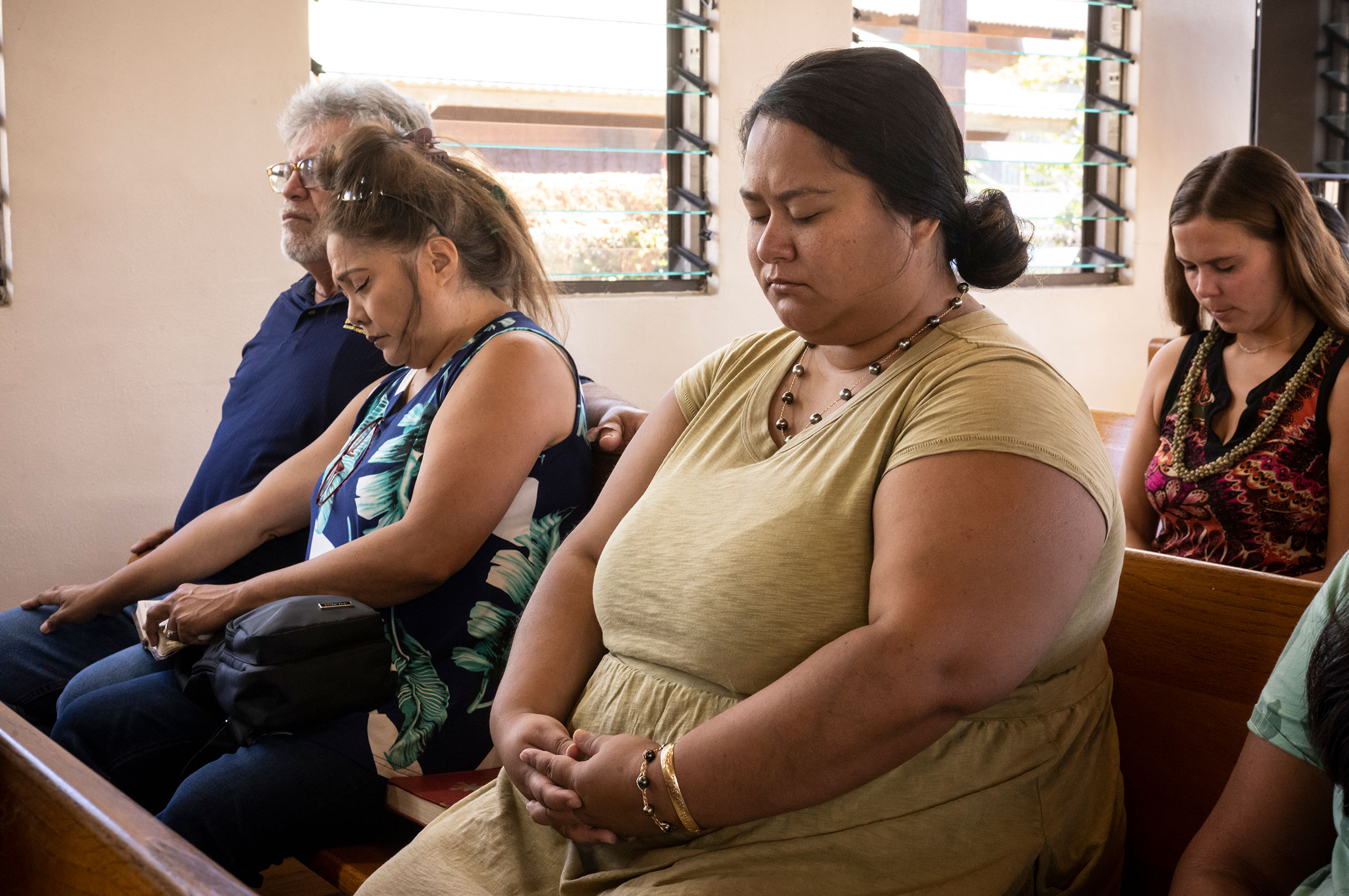 August 13, 2023  Wailuku, Hawaii   At the first Sunday service since the deadly fires last week, parishioners of the Kupaianaha church  pray for healing after the tragedy. Much of Sunday’s service was devoted to finding purpose in spiritual thoughts and also practical efforts by the community to deliver aid to victimes. Photo by David Butow for TIME.