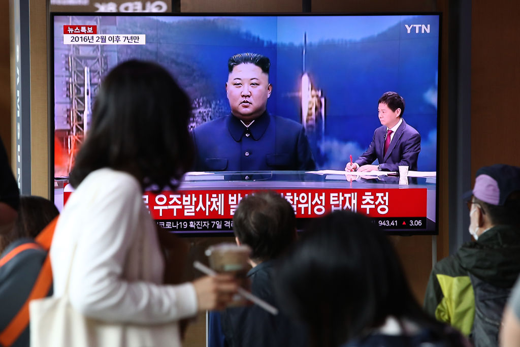 People watch a television broadcast showing a file image of a North Korean rocket launch at the Seoul Railway Station on May 31, 2023 in Seoul, South Korea.