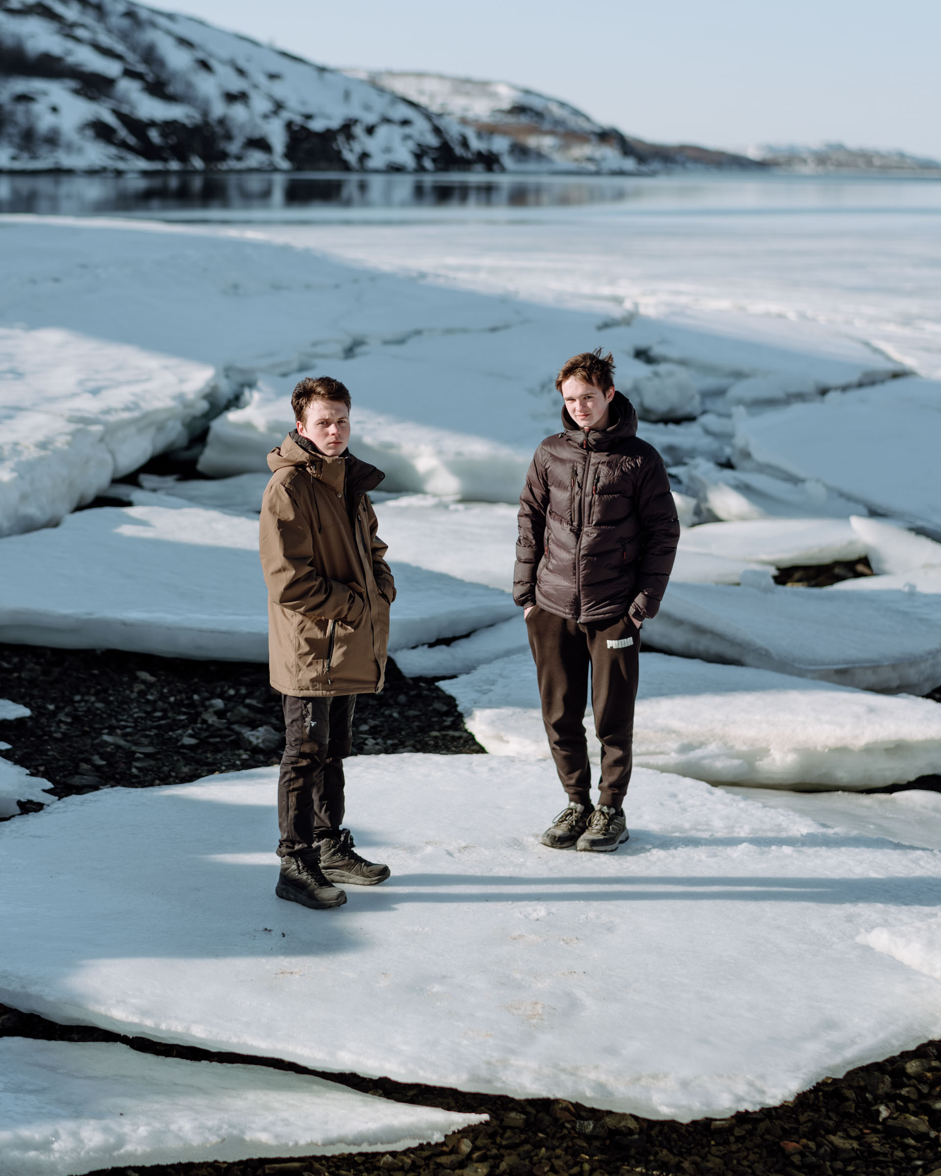 Sasha Buluiev, 20, and Yuri London, 18, stand on ice patches near Kirkenes where they are taking Norwegian lessons in school and looking for work. Both of their fathers are currently serving in the Ukrainian military. Yuri keeps in touch with his father daily on messaging apps. "I didn't hear from him for like 24 hours before...and I was losing my fucking mind," he said.