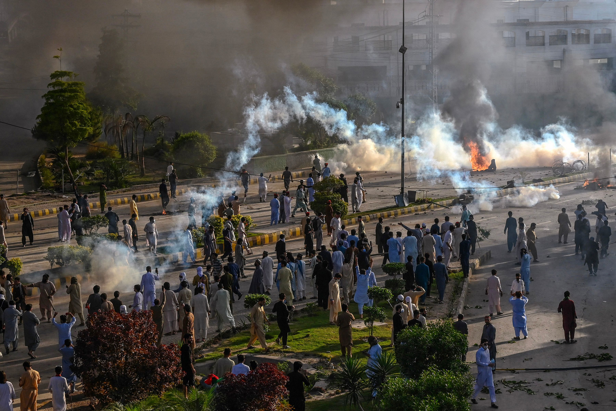 Police fire teargas shell towards PTI party activists and supporters of former Pakistan's Prime Minister Imran Khan during a protest against the arrest of their leader in Peshawar on May 9.