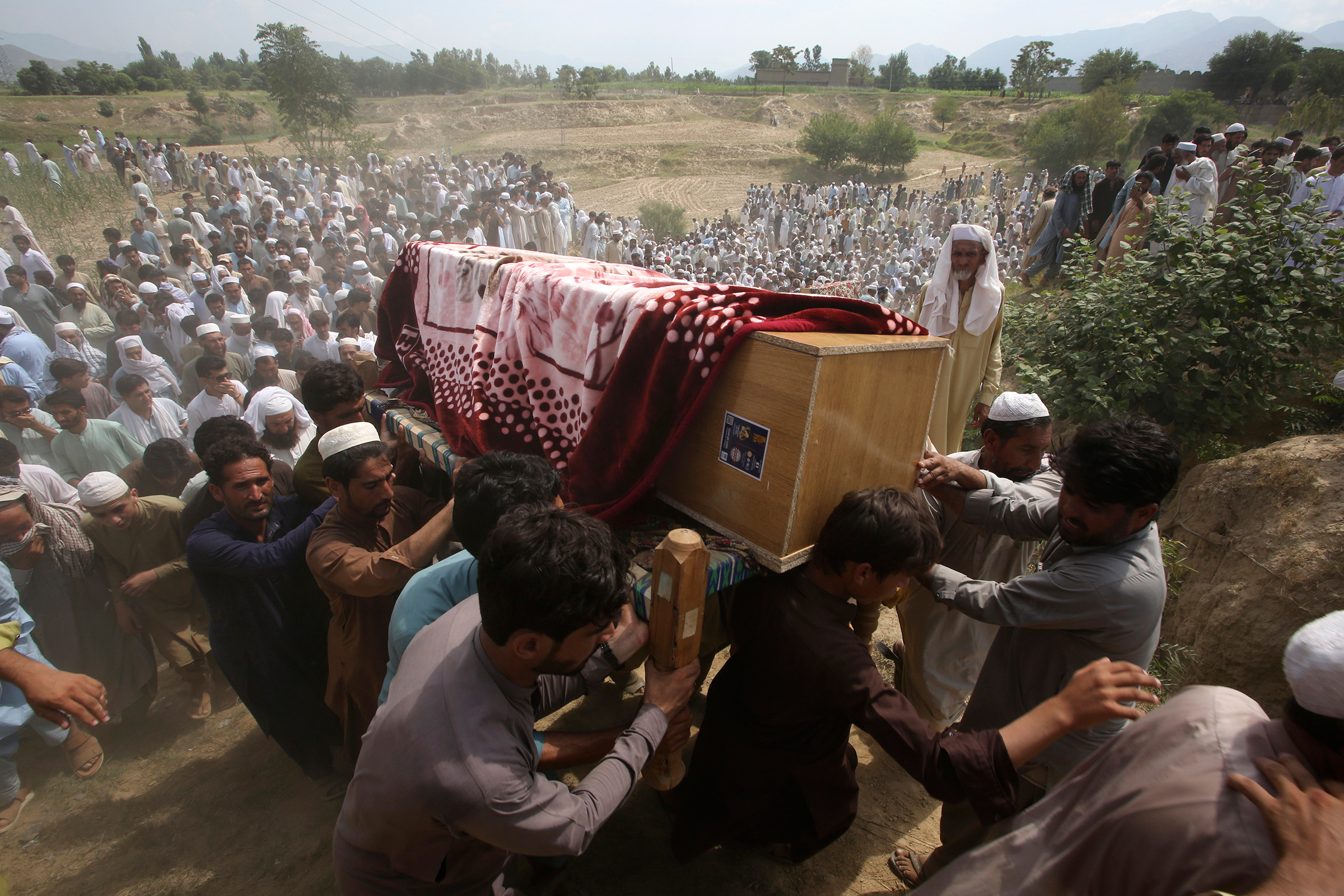 Relatives and mourners carry the casket of a victim killed in a suicide bomber attack in Bajaur district, Pakistan, on July 31.