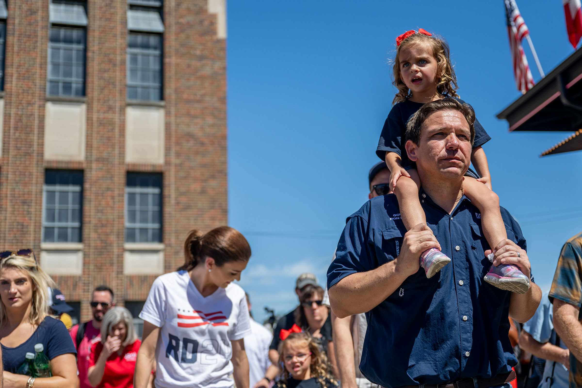 Florida Governor Ron DeSantis, with his daughter Mamie on his shoulders, walks through the Iowa State Fair in Des Moines on Aug. 12, 2023. (Brandon Bell—Getty Images)