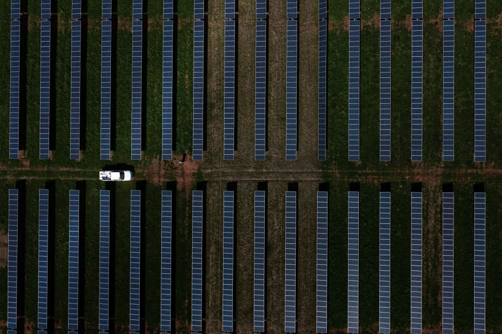 A vehicle drives through a solar farm in Plains, Georgia, on Feb. 22, 2023.