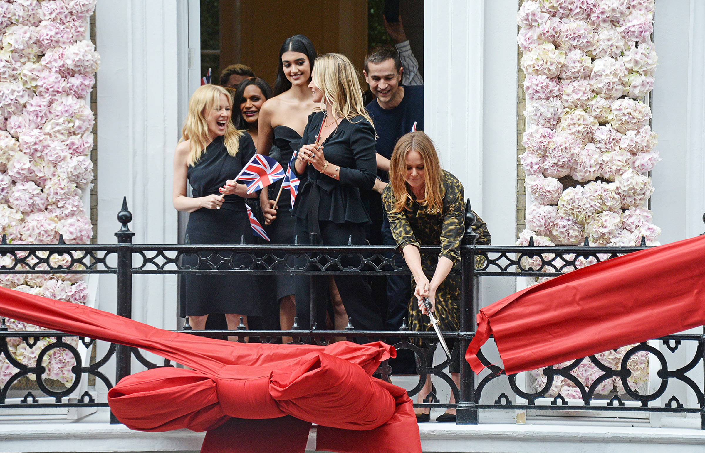 McCartney cuts the ribbon at her flagship store on Old Bond Street in London, in June?2018, 
                      with Kylie Minogue, Mindy Kaling, Neelam Gill, and Kate Moss (David M. Benett—Getty Images for Stella McCartney)