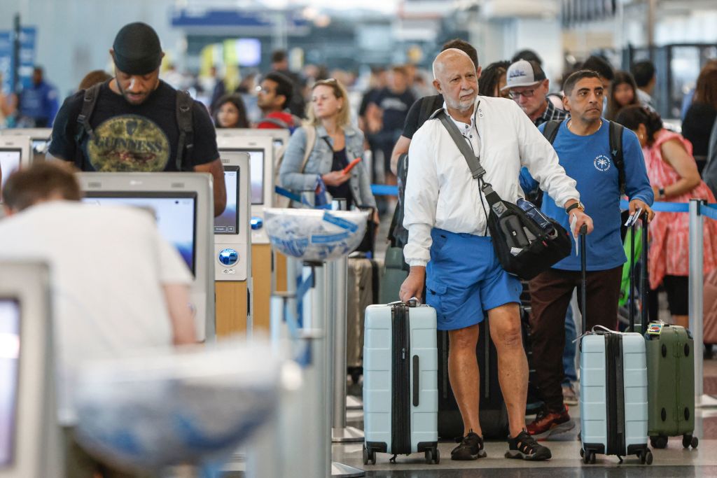 Travelers arrive at O'Hare International Airport in Chicago, Illinois, on June 30, 2023.  (KAMIL KRZACZYNSKI—AFP/Getty Images)