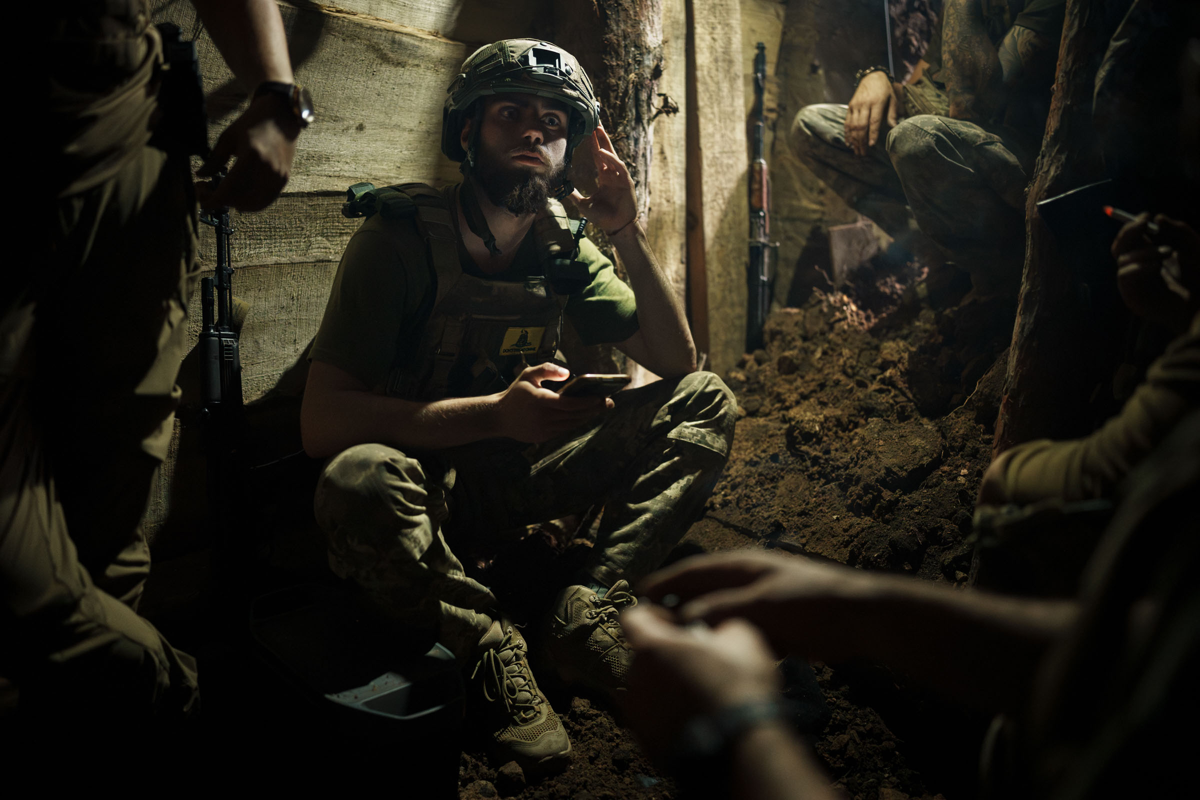 Ukrainian soldiers of 3rd Separate Assault Brigade hide in a dugout during the shelling of Russian tanks and guns on the Bakhmut direction on July 1, 2023 in Donetsk Oblast, Ukraine. Bakhmut and its surroundings continue to be places of most fierce battles since the beginning of the full-scale Russian invasion. (Serhii Mykhalchuk—Global Images Ukraine/Getty Images)