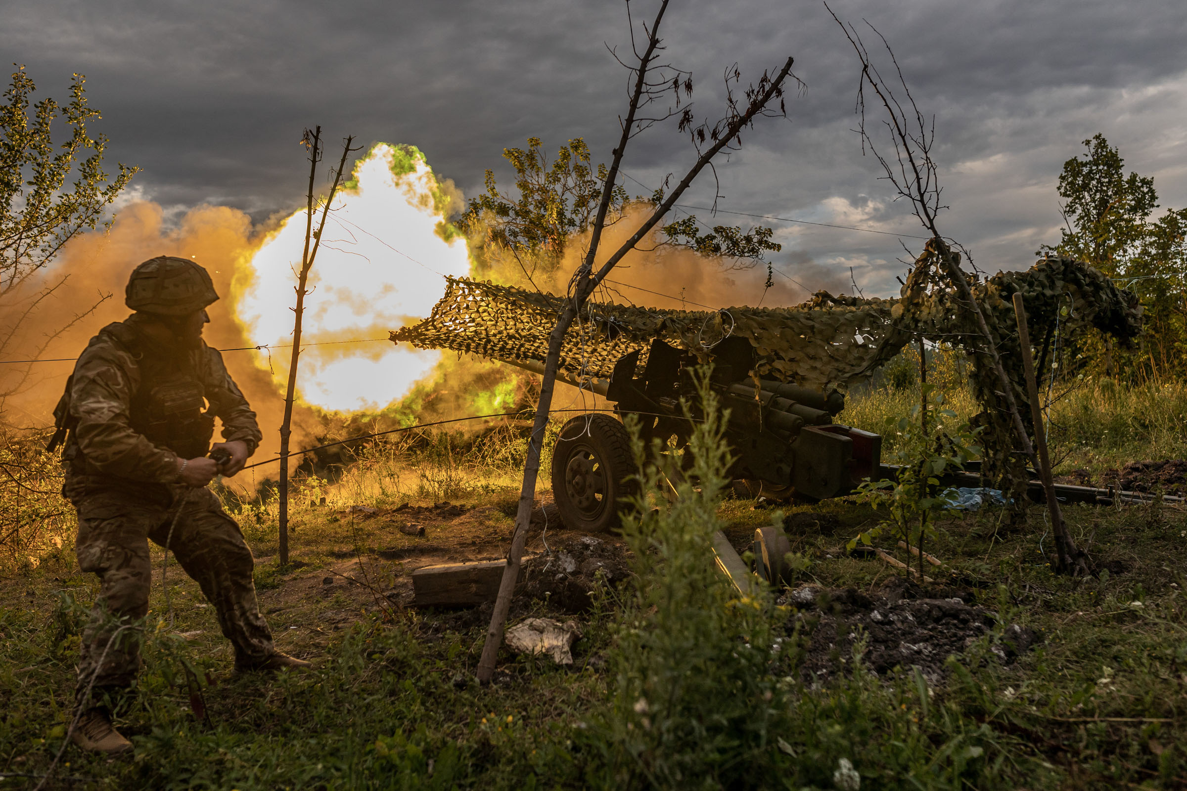 Ukrainian soldier firing artillery in the direction of Bakhmut, Ukraine, July 22, 2023. (Diego Herrera Carcedo—Anadolu Agency/Getty Images)