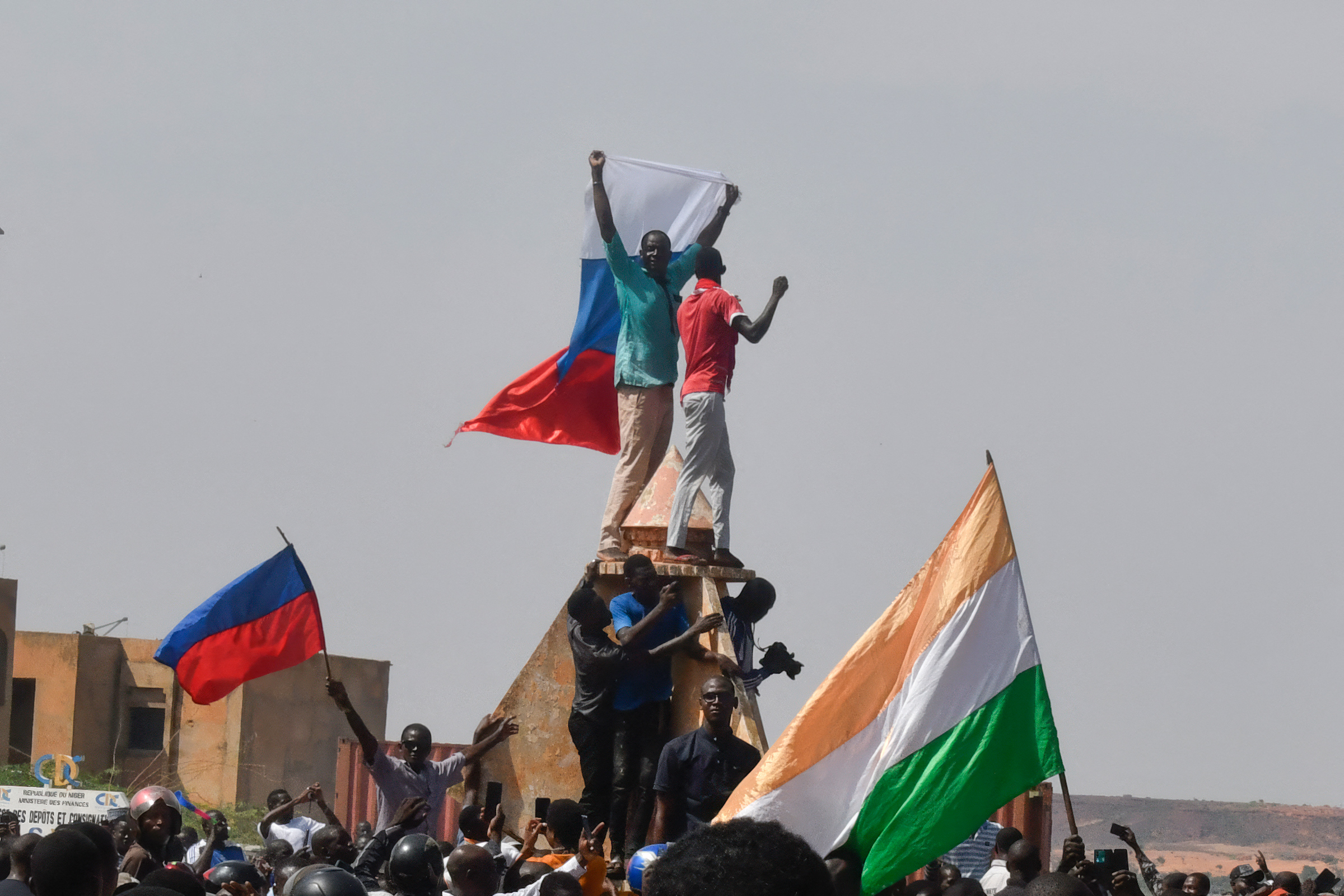 Protesters wave Nigerien and Russian flags as they gather during a rally in support of Niger's junta in Niamey, Niger, on July 30.
