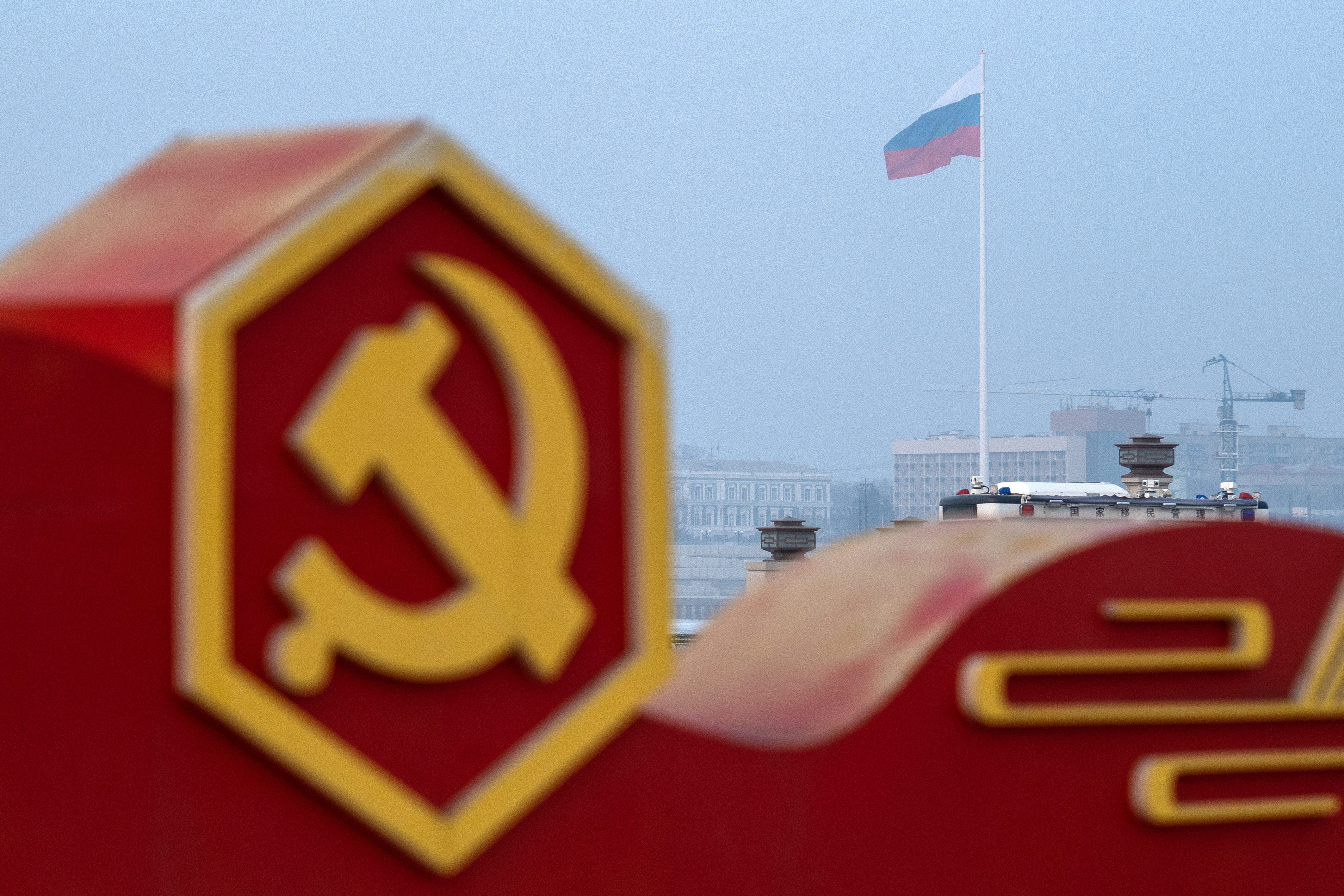A Russian flag can be seen in Blagoveshchensk, Russia, across the Amur River from Heihe, China, in March 2023. (Bloomberg/Getty Images)