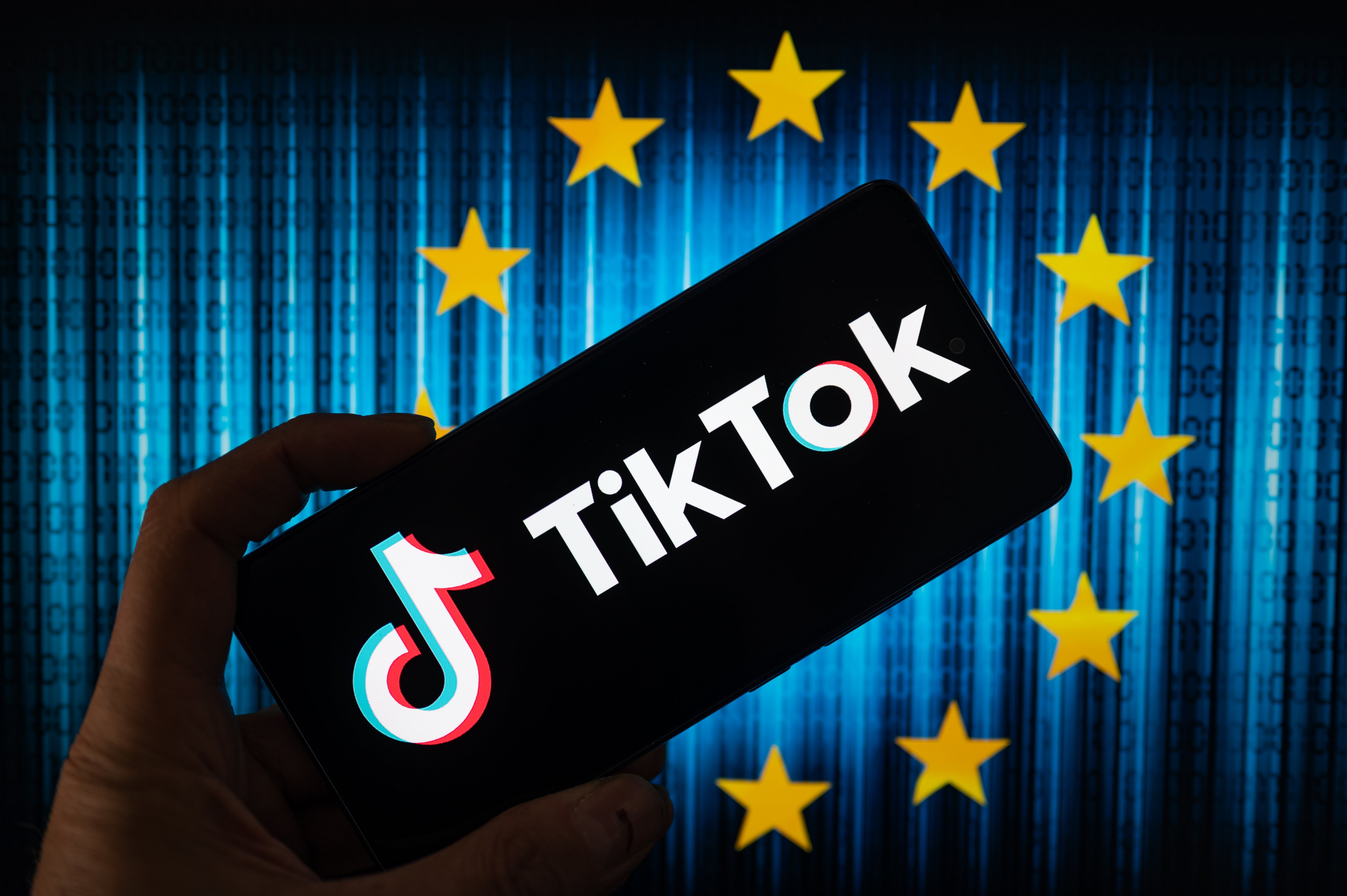 TikTok icon displayed on a phone screen with the European Union stars in the background. (Jonathan Ra—NurPhoto/Getty Images)