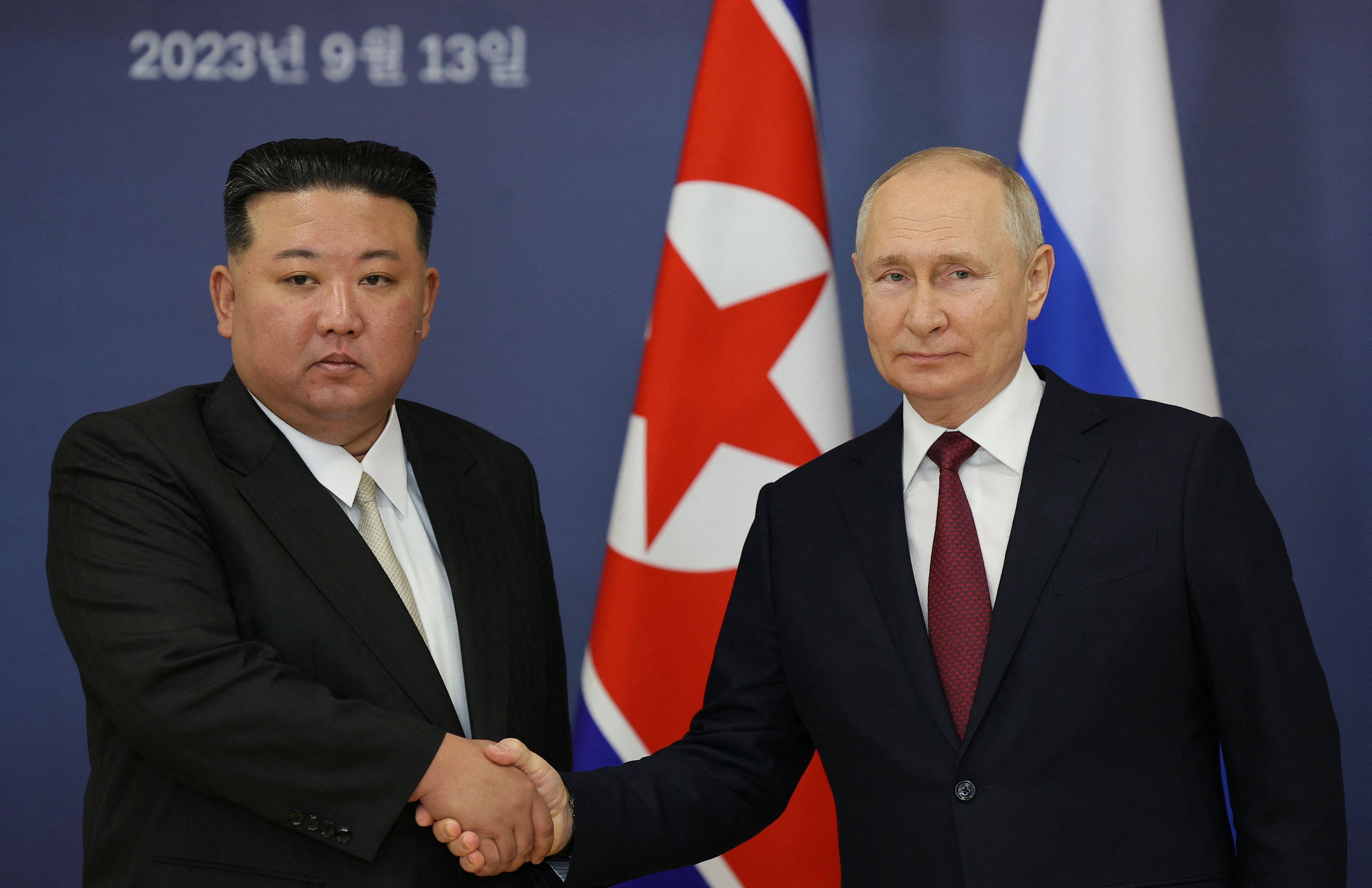 Kim Jong Un and Vladimir Putin shake hands as they met in Russia on Sept. 13, 2023. (Vladimir Smirnov—Sputnik/Pool/AFP/Getty Images)