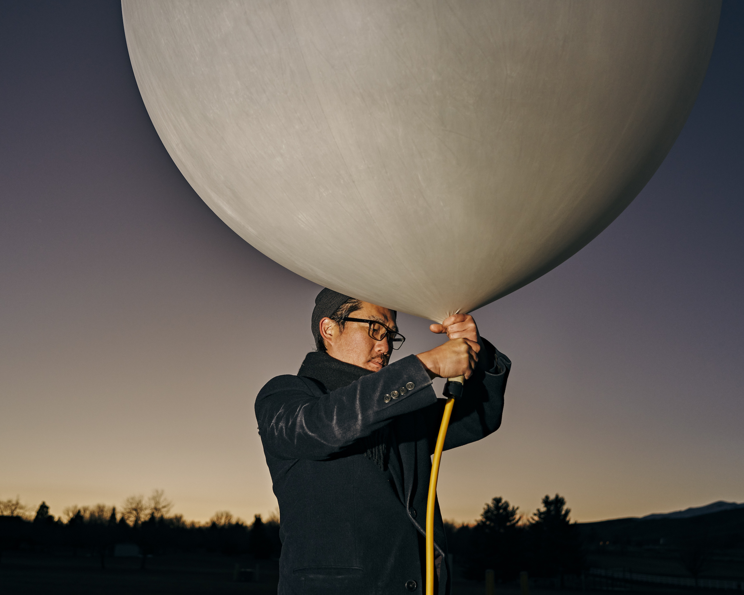 Co-founder Andrew Song of solar geoengineering startup Make Sunsets holds a weather balloon filled with helium, air and sulfur dioxide at a park in Reno, Nevada, United States on February 12, 2023.