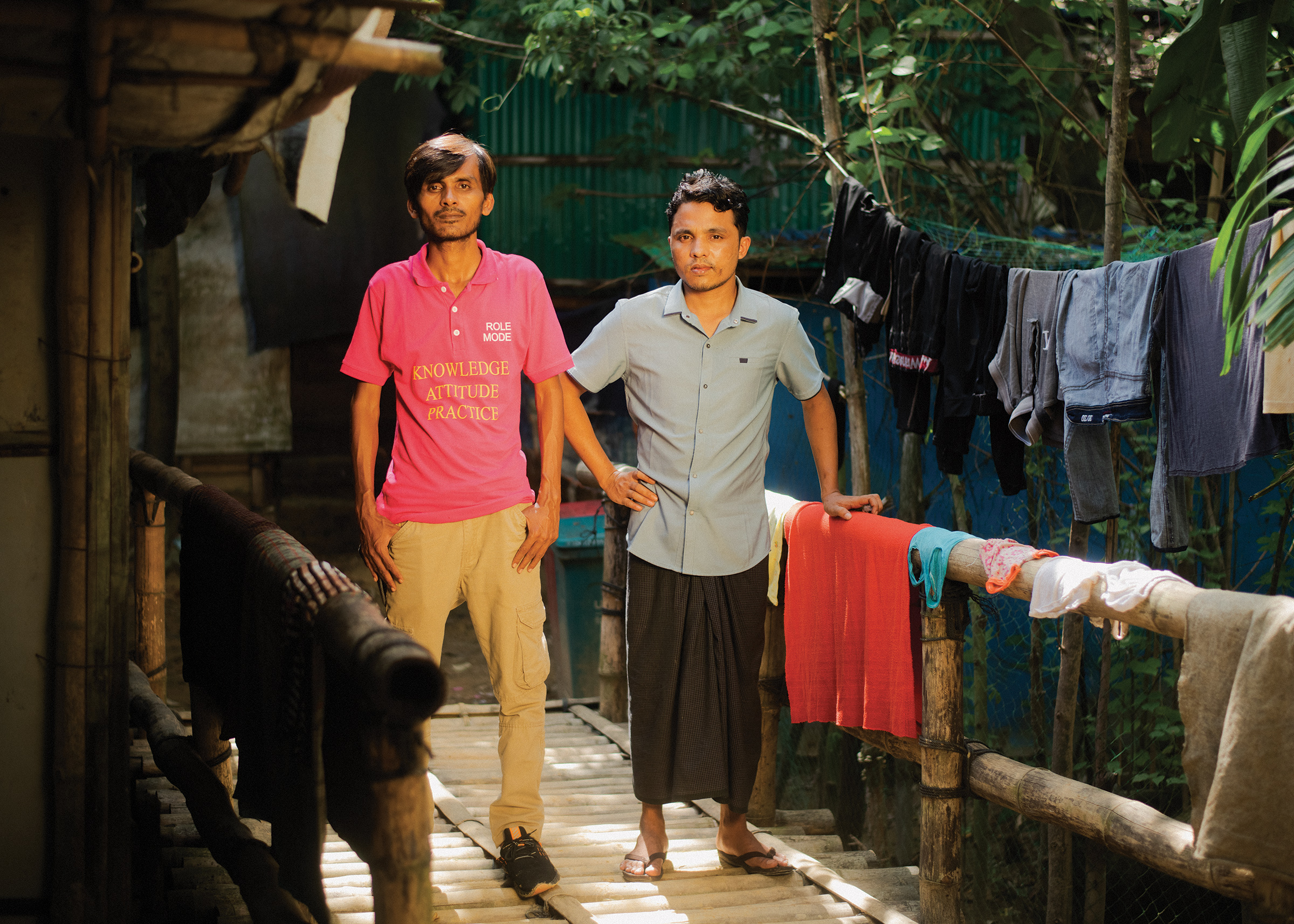 From left: Sayed Alom, 35, a community activist working in Kutupalong; with Anuwar Shah, 25, a teacher in the camp whose younger brother, Nur Komal, was arrested inside Myanmar after fleeing on a trafficker's boat. (Sarker Protick for TIME)