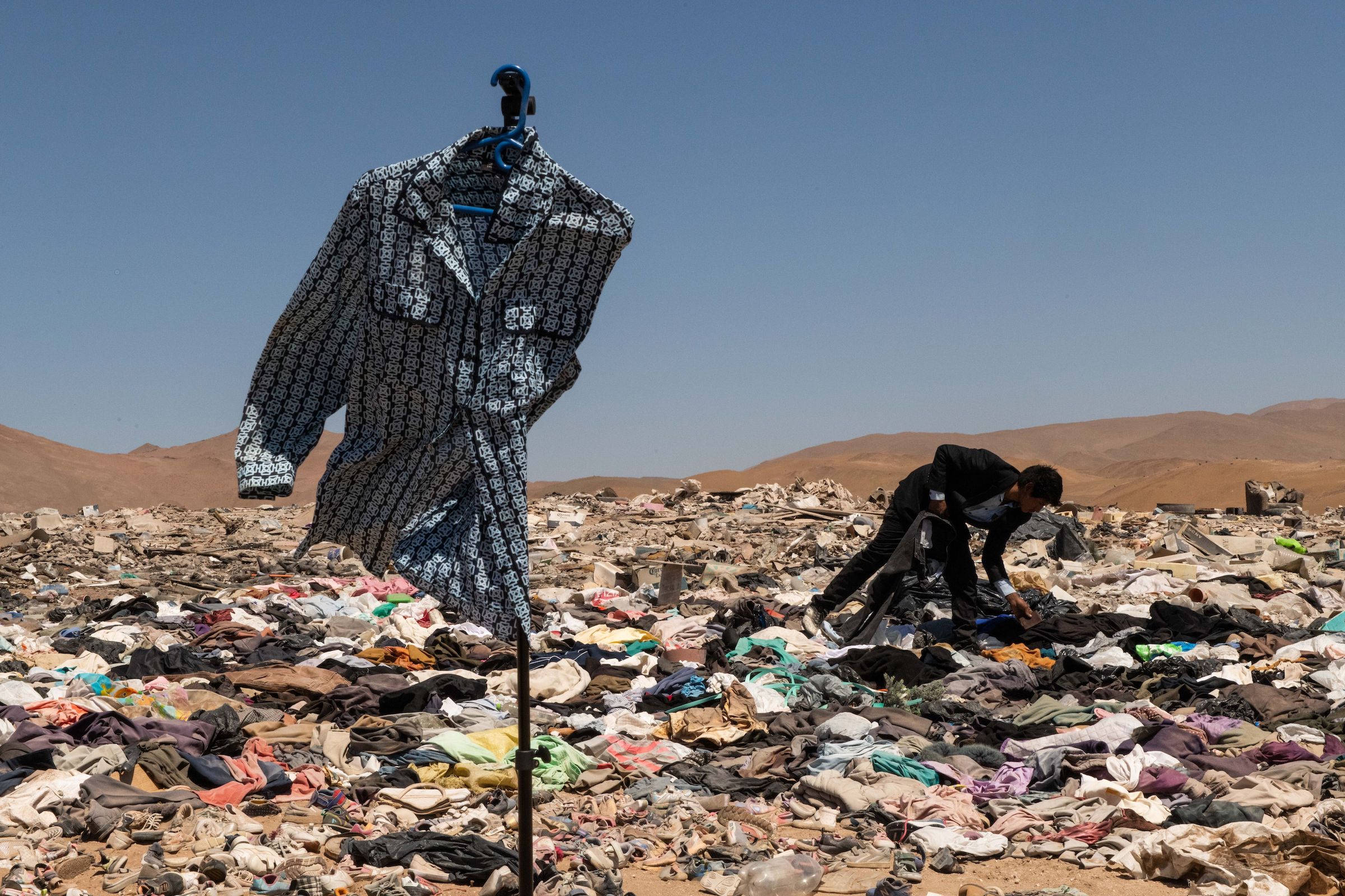 Millions of pieces of clothing lying in the middle of the desert are burned and turned into ash. Chile, May 2022.  (Mauricio Bustamante—Visum/Redux )