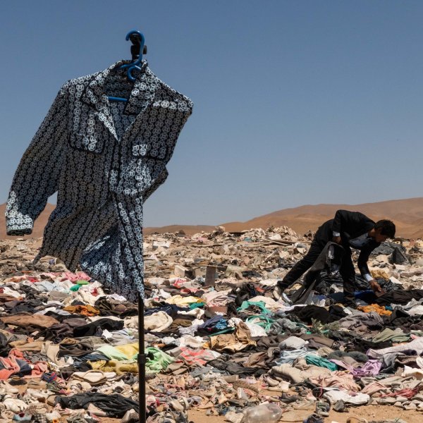 Millions of pieces of clothing lying in the middle of the desert are burned and turned into ash. Chile, May 2022.