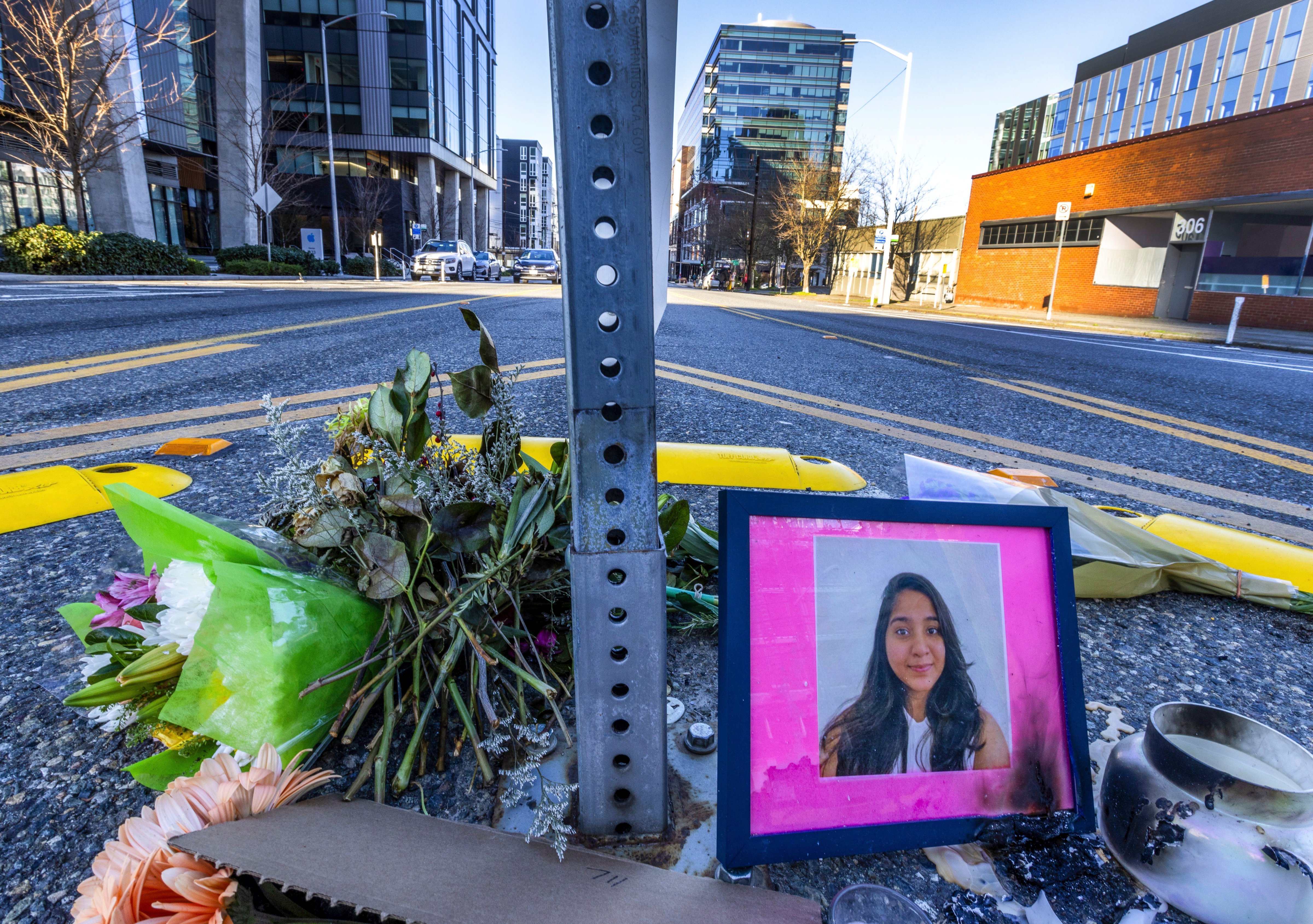 A photo of Jaahnavi Kandula is displayed with flowers on Jan. 29, 2023 in Seattle, at the intersection where she was killed by a Seattle Police officer. (Ken Lambert—The Seattle Times/AP)